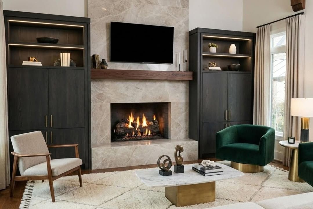 Modern living room with fireplace, wall-mounted TV, dark built-ins, and green accent chair