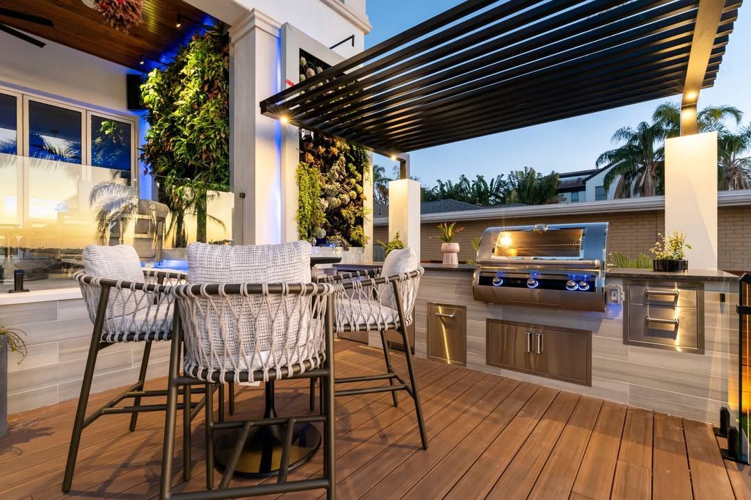 Modern outdoor patio with dining table, grill, and pergola at dusk