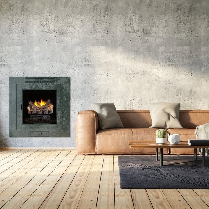 Modern living room with a wall-mounted fireplace, tan sofa, coffee table, and dark rug on wooden floors