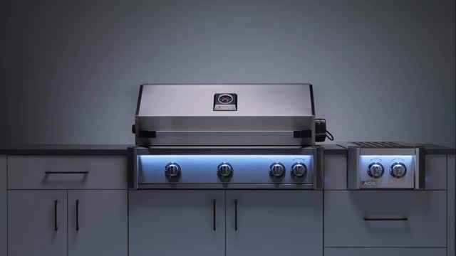 Modern stainless steel gas grill on a gray outdoor patio, with cabinet doors and side burner.