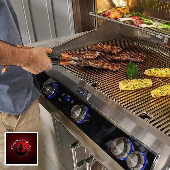 Person grilling steaks and corn on a stainless steel barbecue indoors