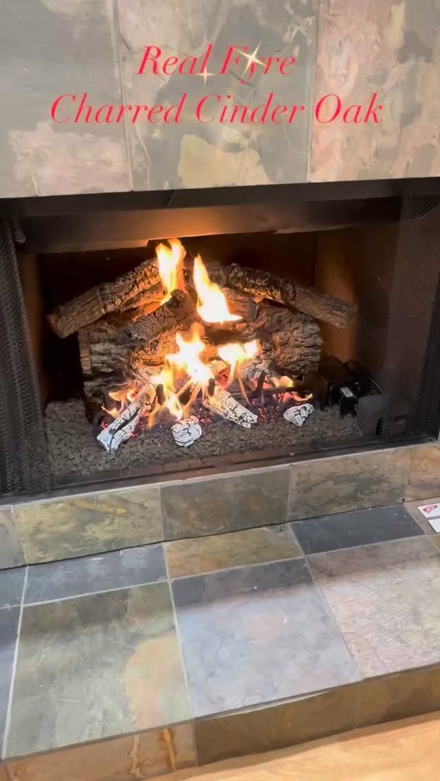 Lit fireplace with burning logs and tiled hearth; red text reads “Red Fox Charred Cinder Oak”