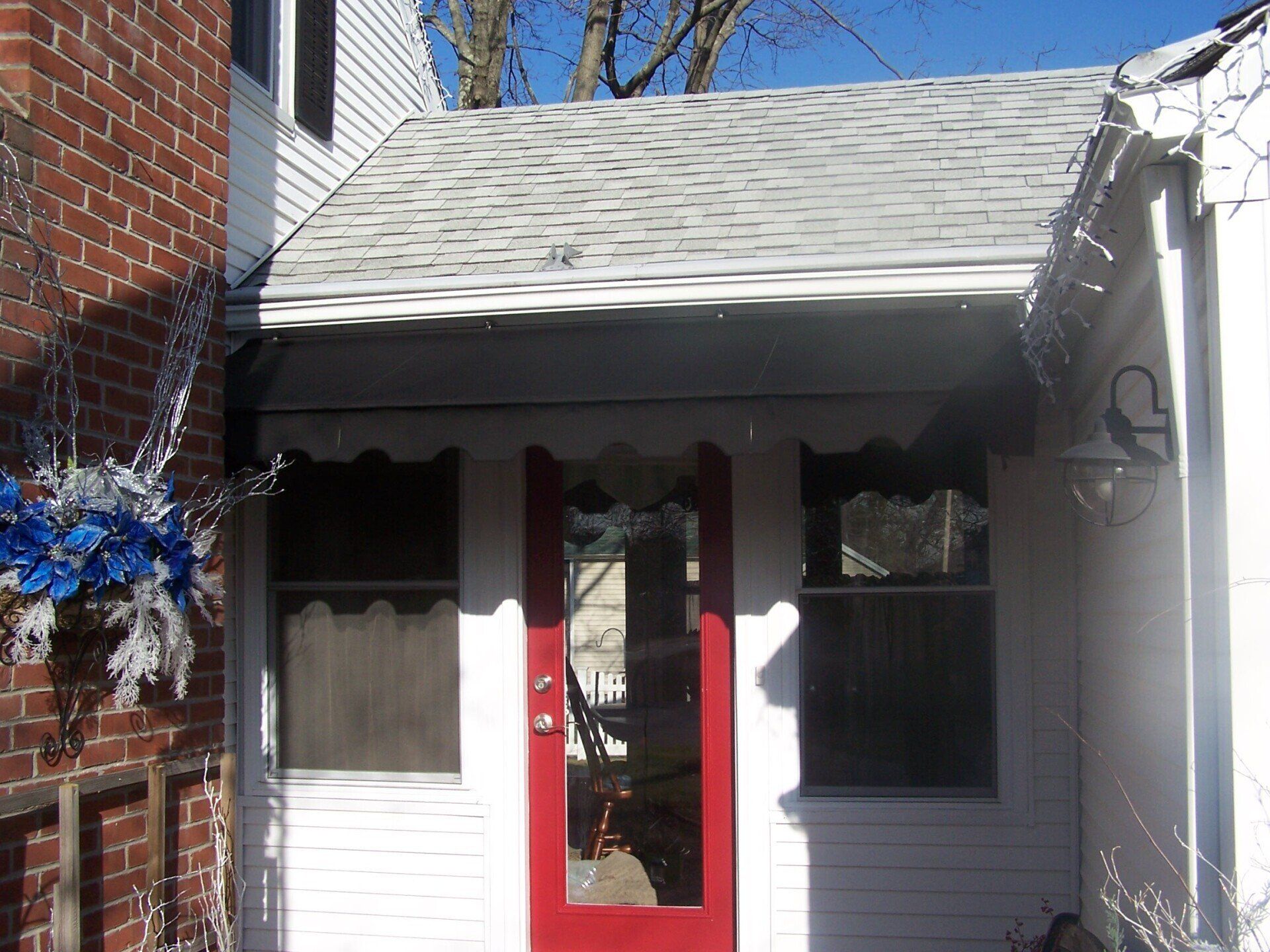 A white house with a red door and a white roof