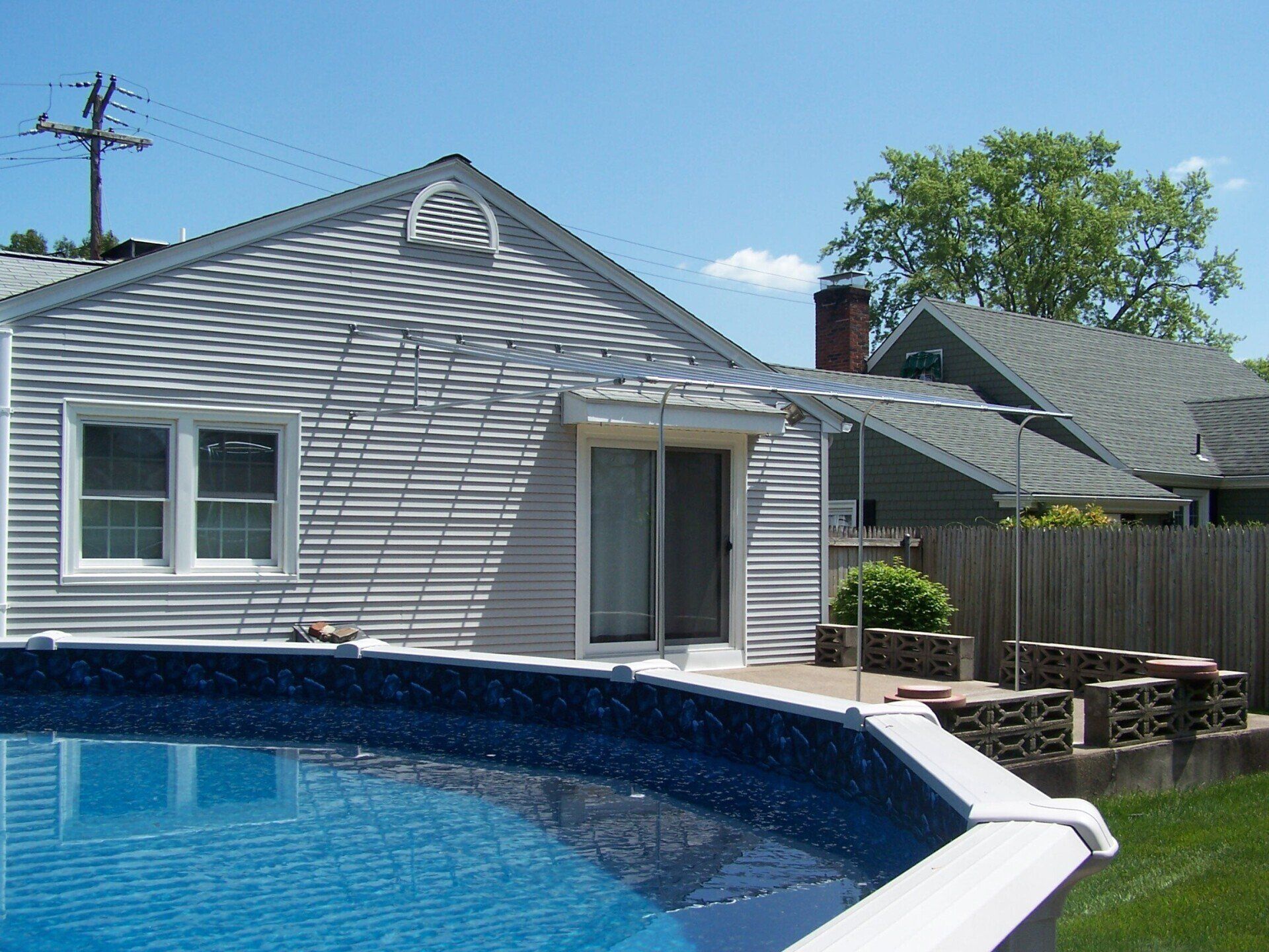 A house with a swimming pool in front of it
