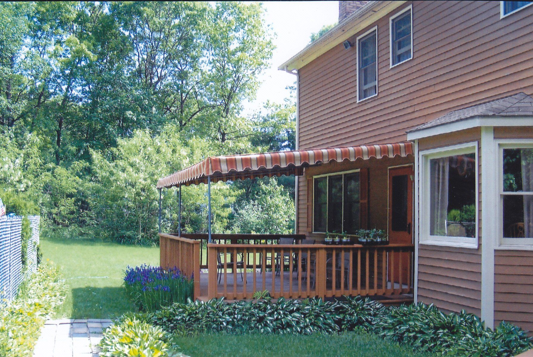 A house with a deck and awning on it