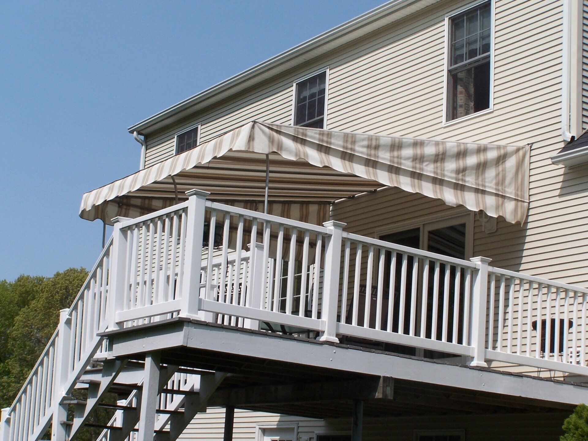 A deck with a canopy and stairs leading up to it