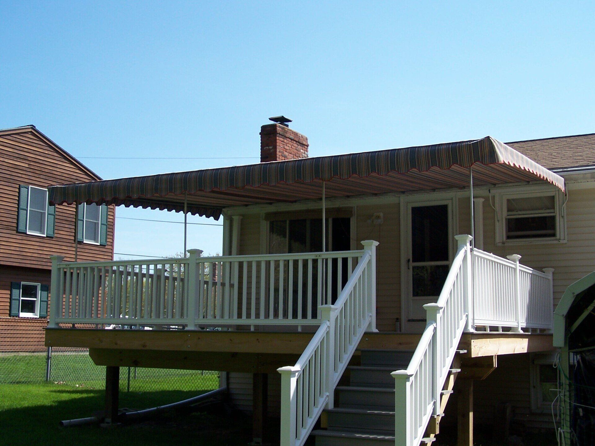 A house with a deck and stairs leading up to it