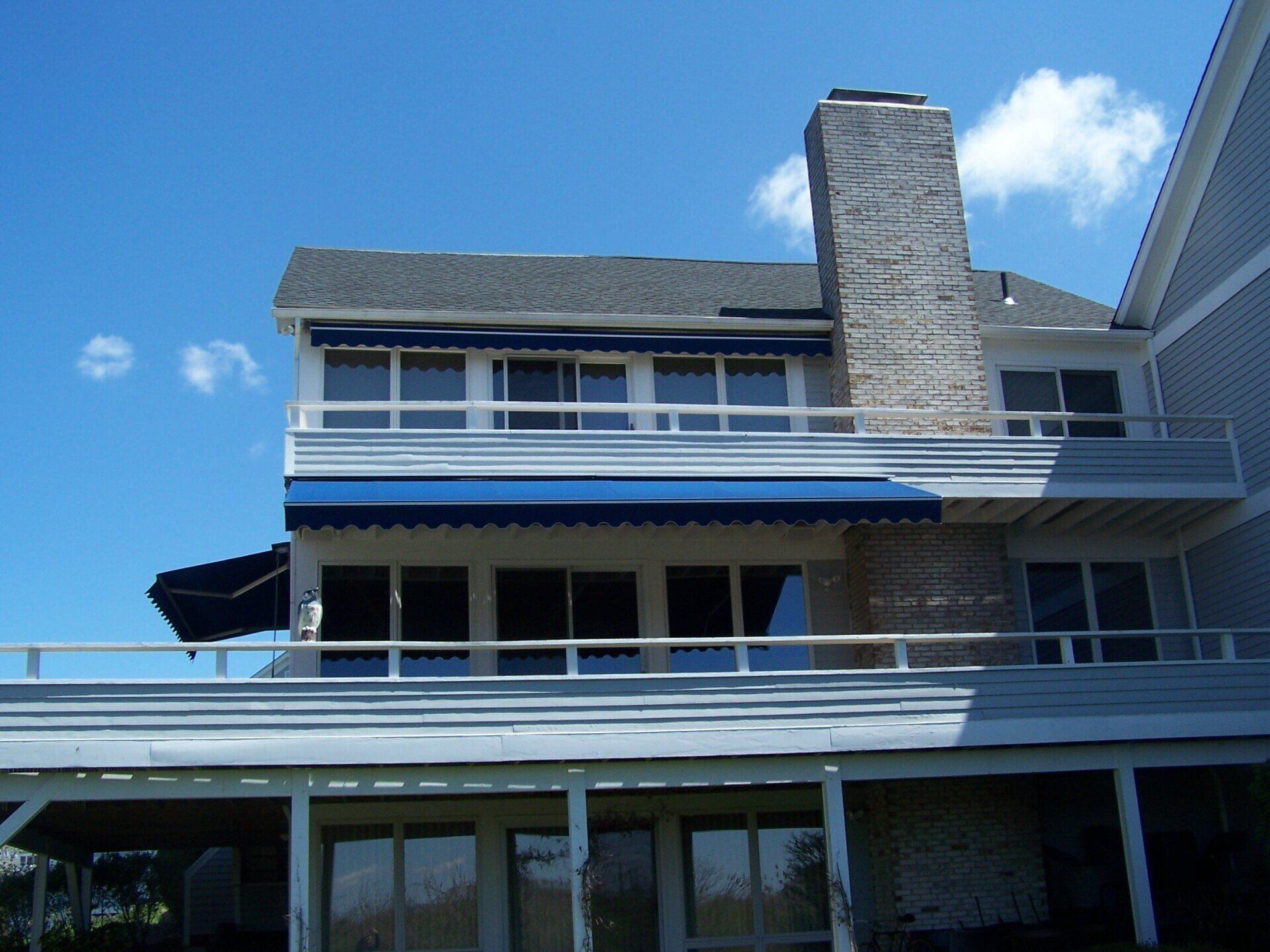 A large house with a blue awning on the roof