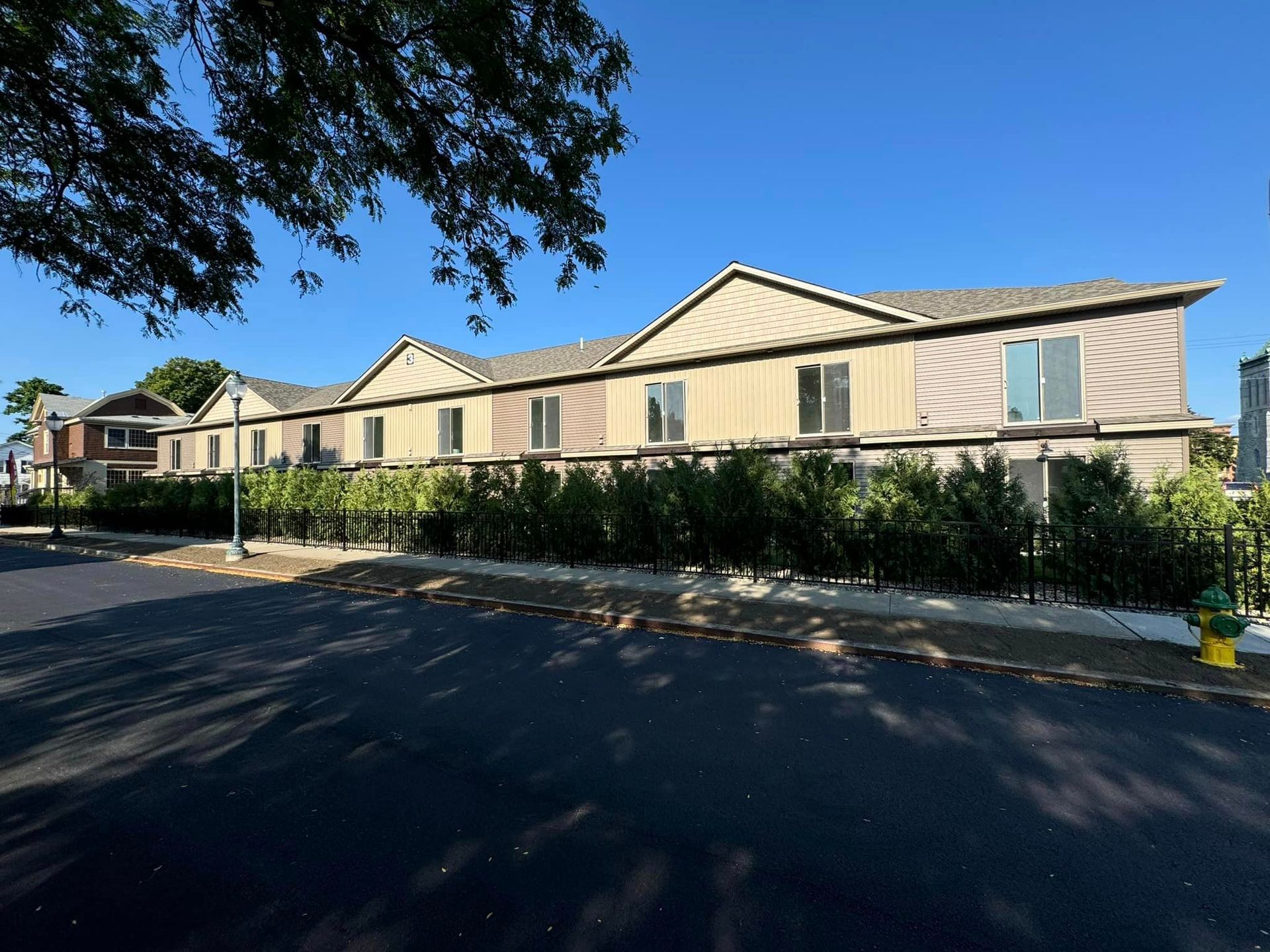 A building with a lot of windows and a fire hydrant in front of it