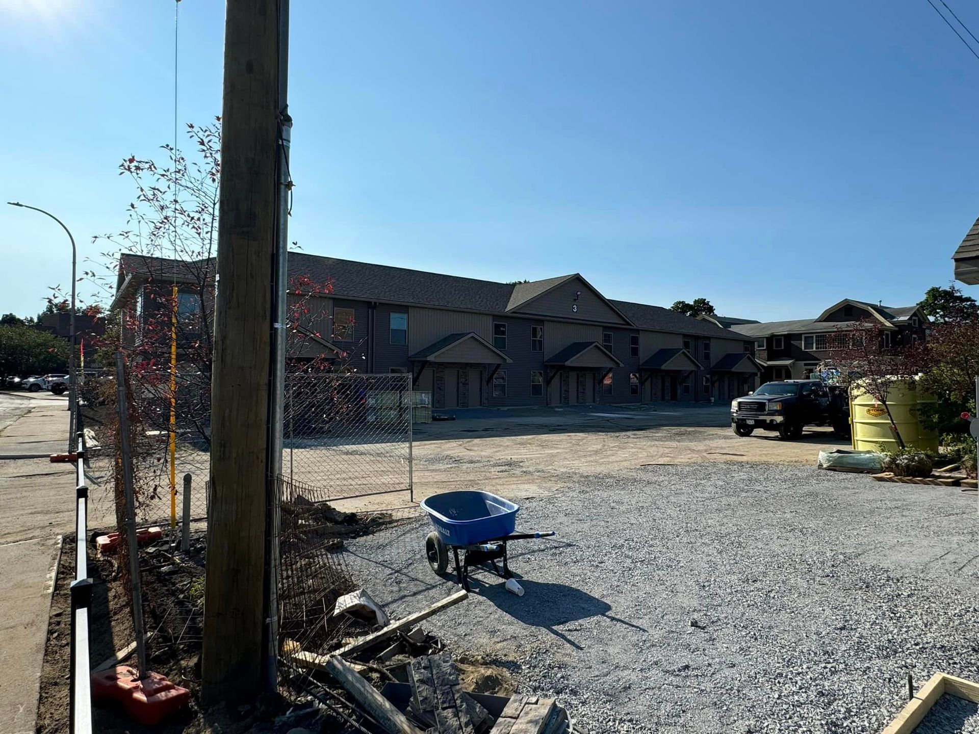A blue wheelbarrow is parked in front of a building