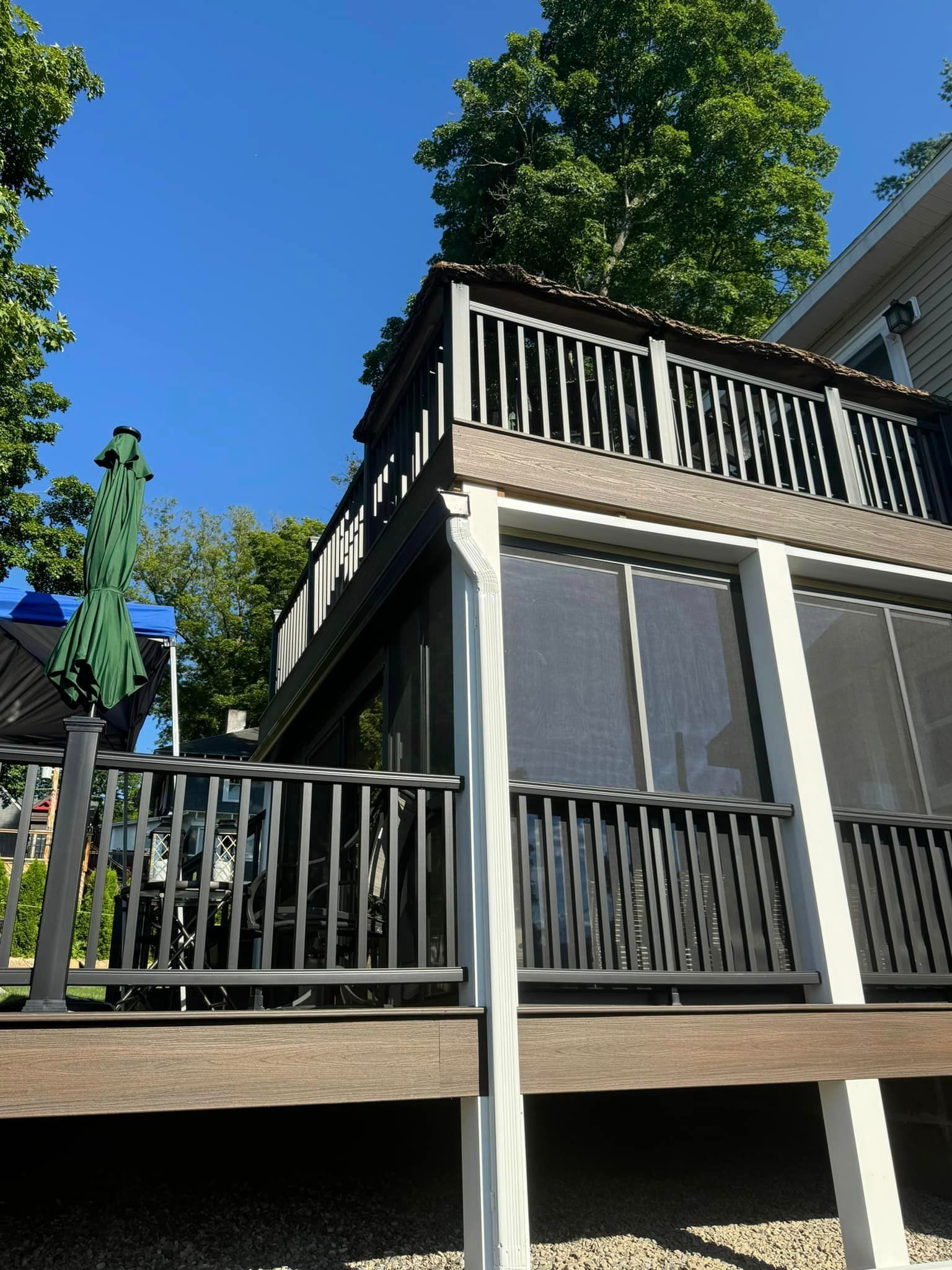 A house with a large deck and a screened in porch