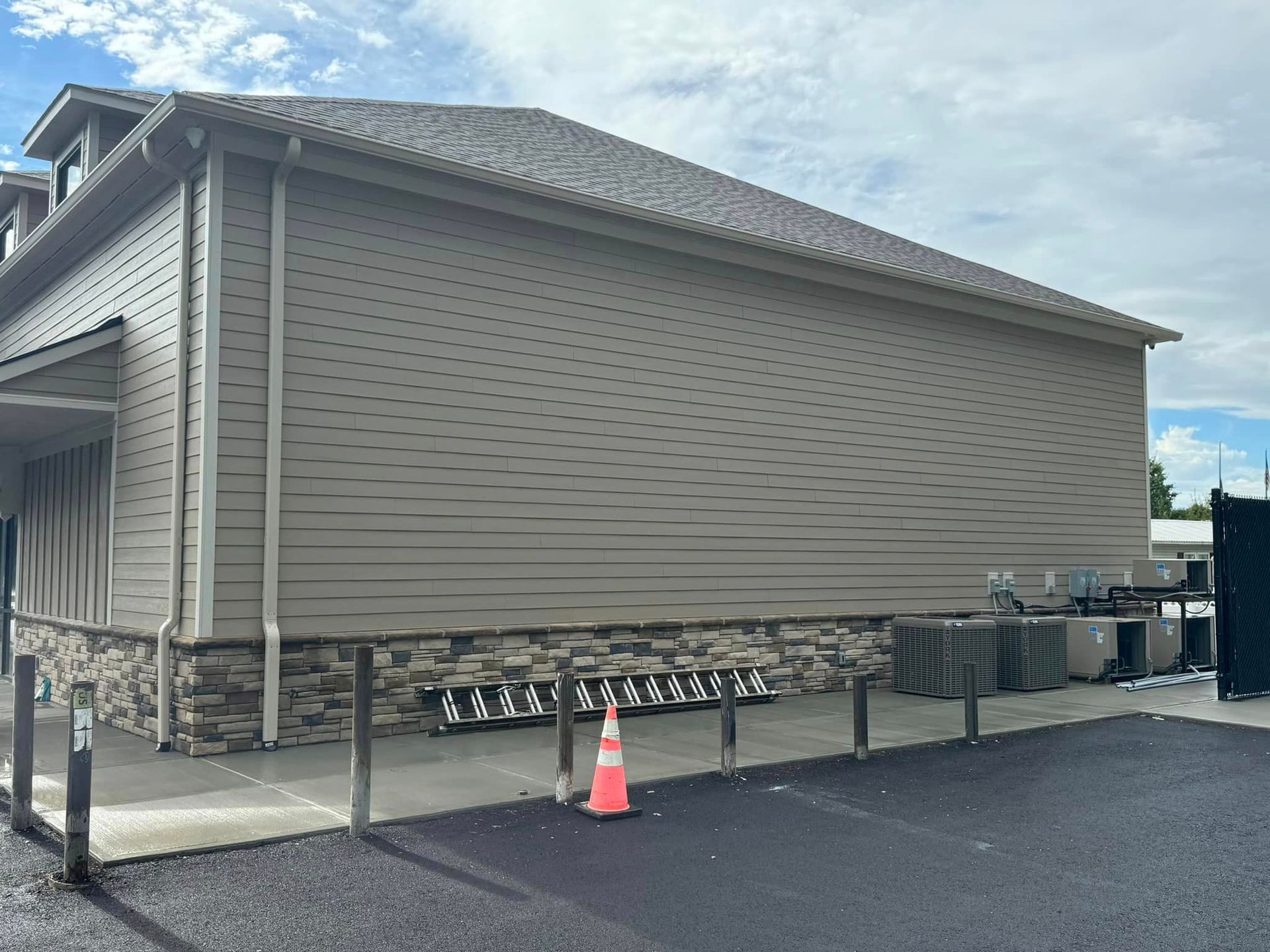 The side of a building with a cone in front of it