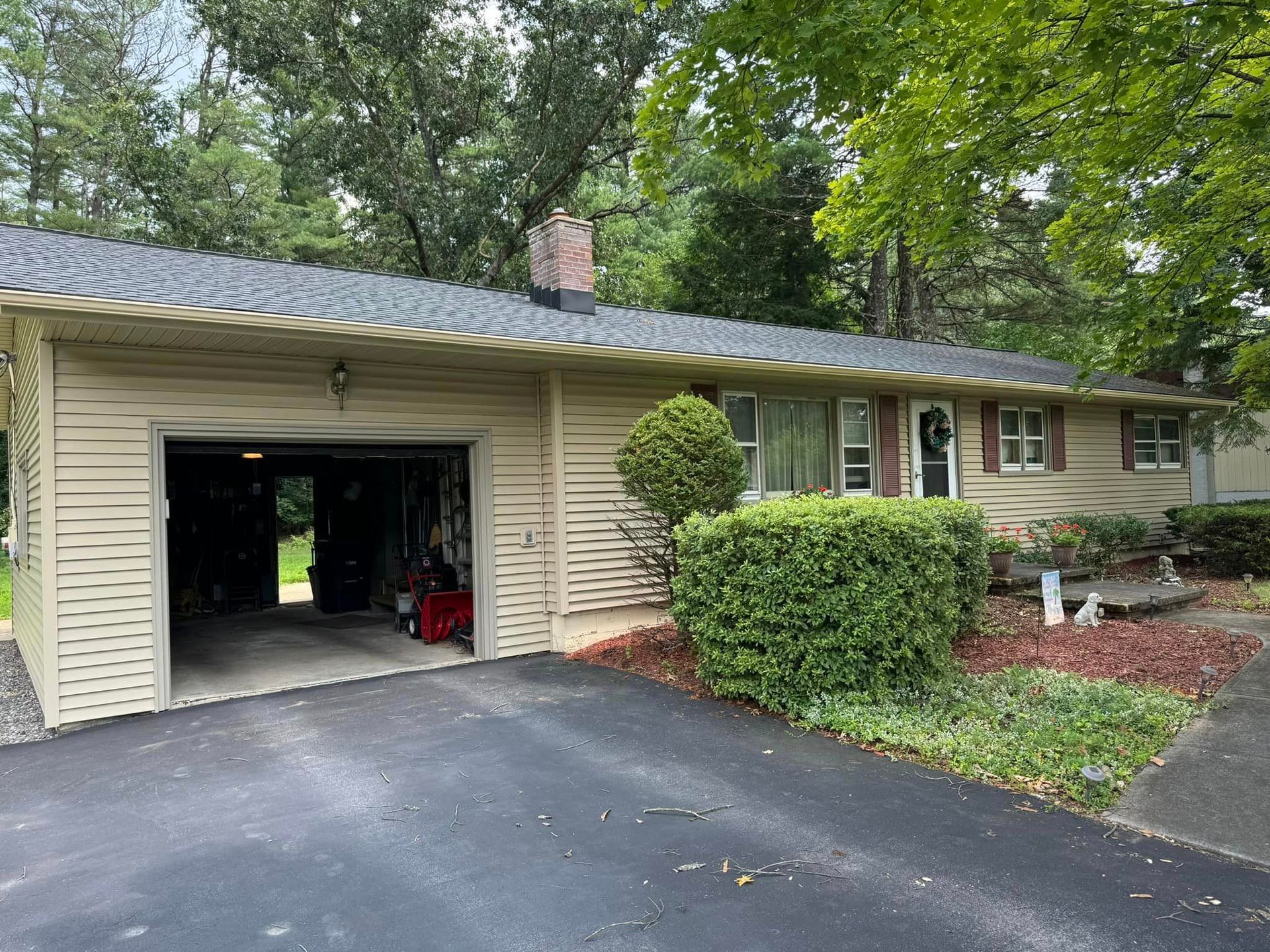 A house with a garage and a driveway in front of it