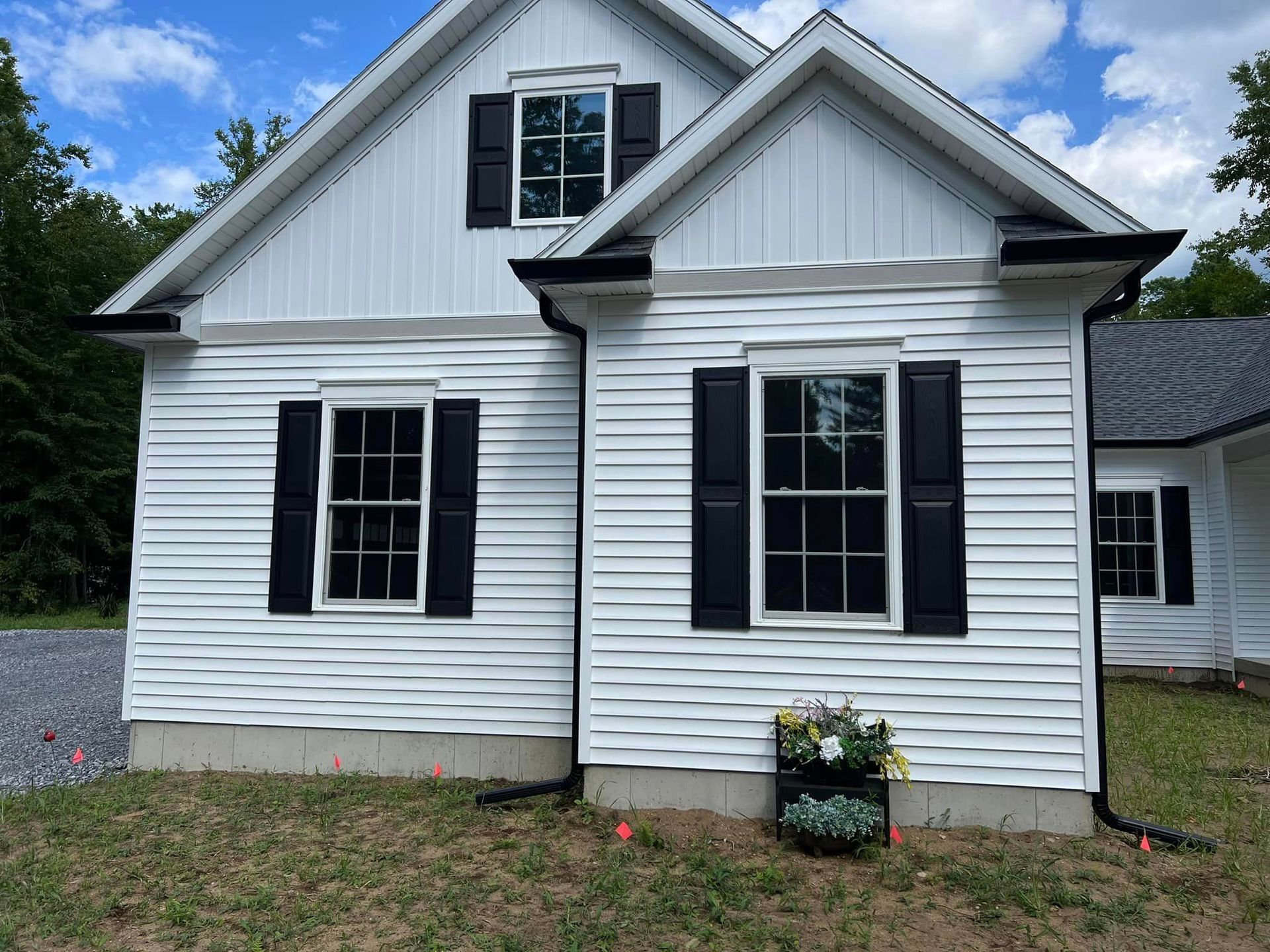 A white house with black shutters on the windows
