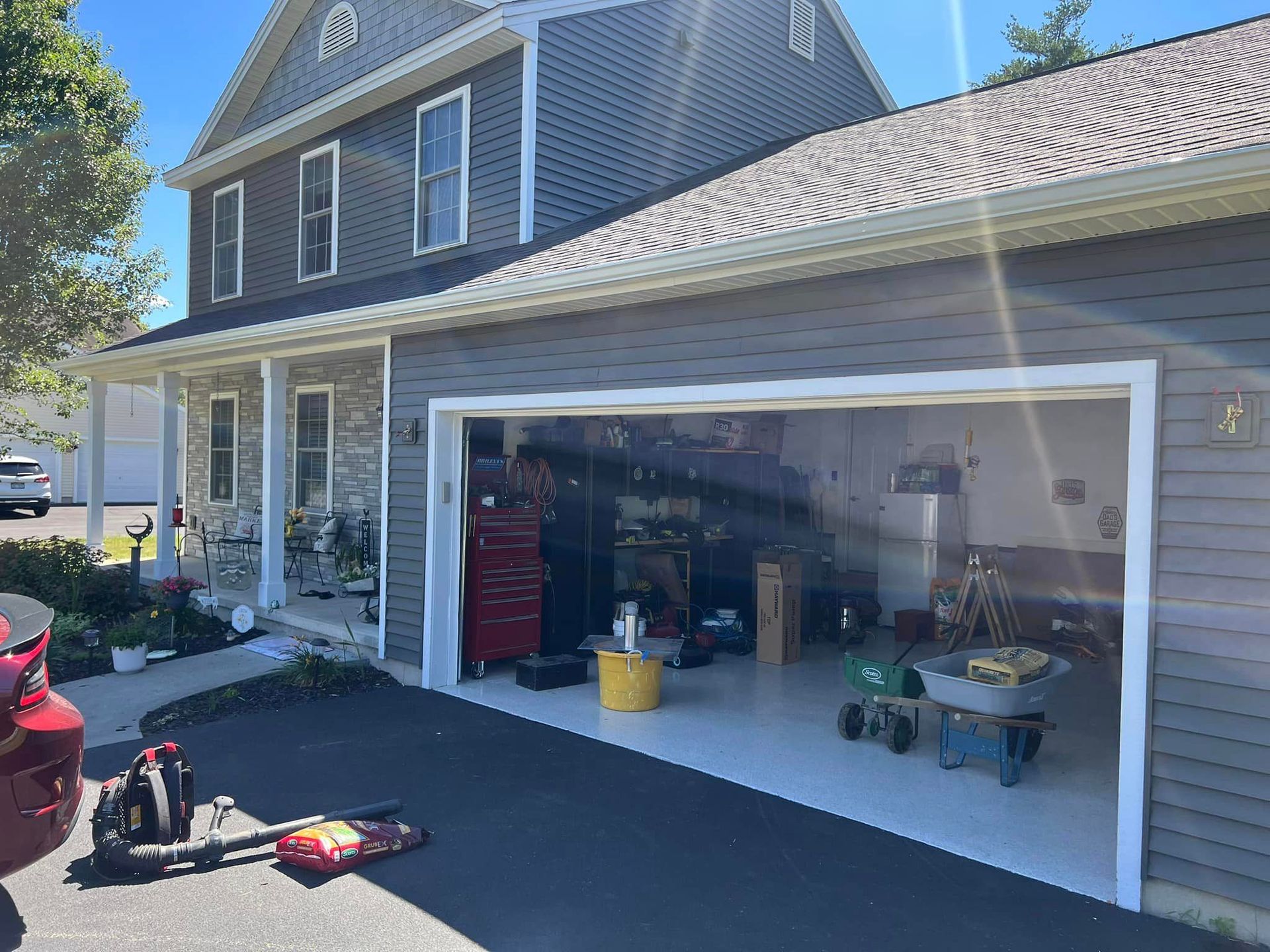 A house with a garage and a car parked in front of it