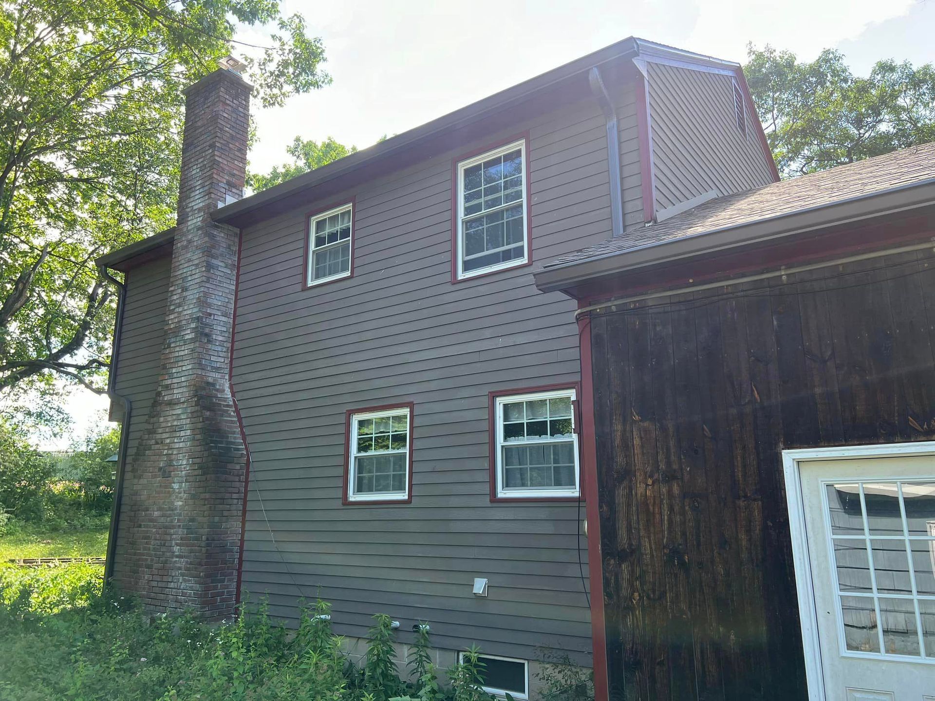 A large house with a lot of windows and a chimney