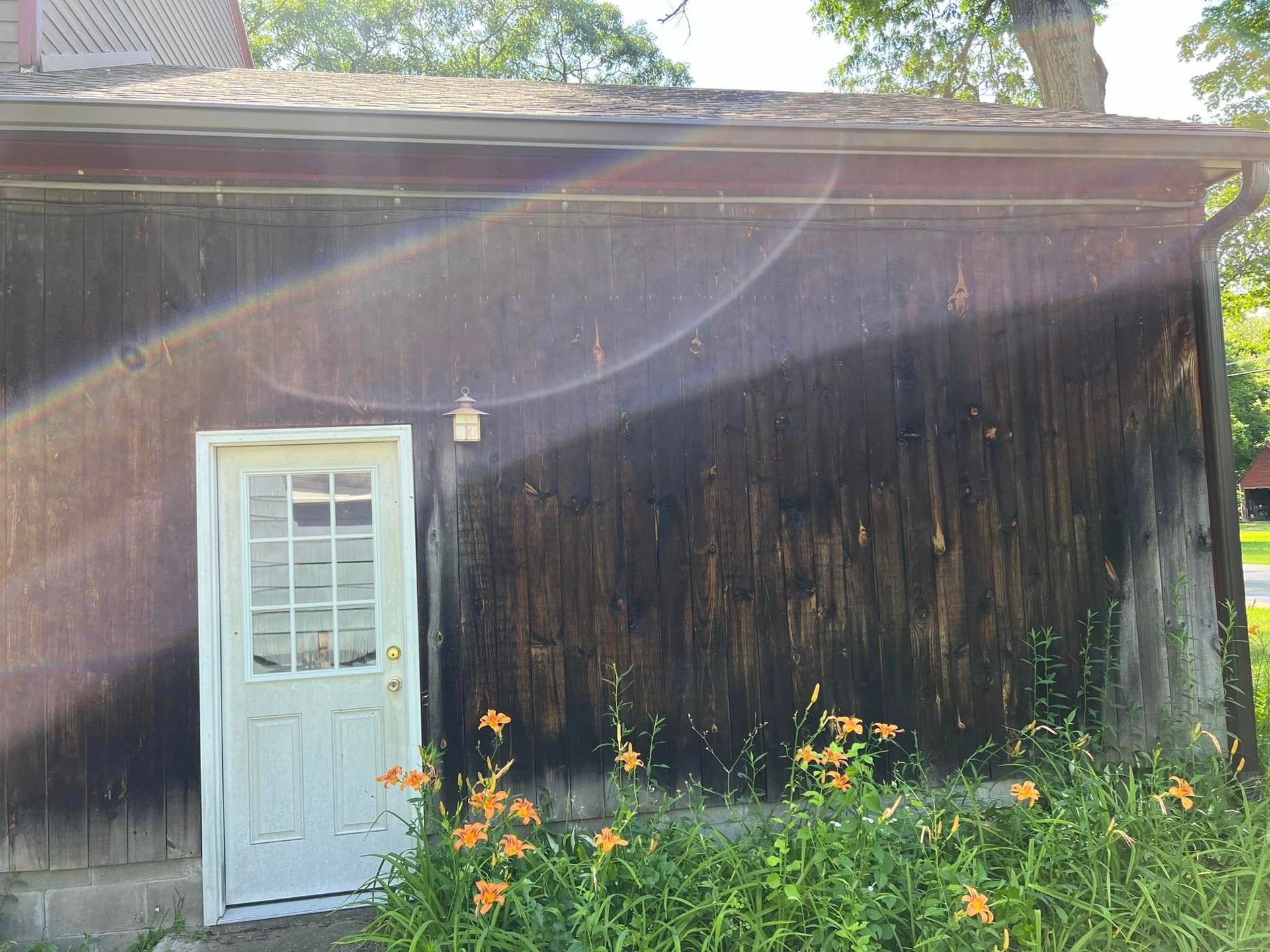 There is a white door on the side of a wooden building