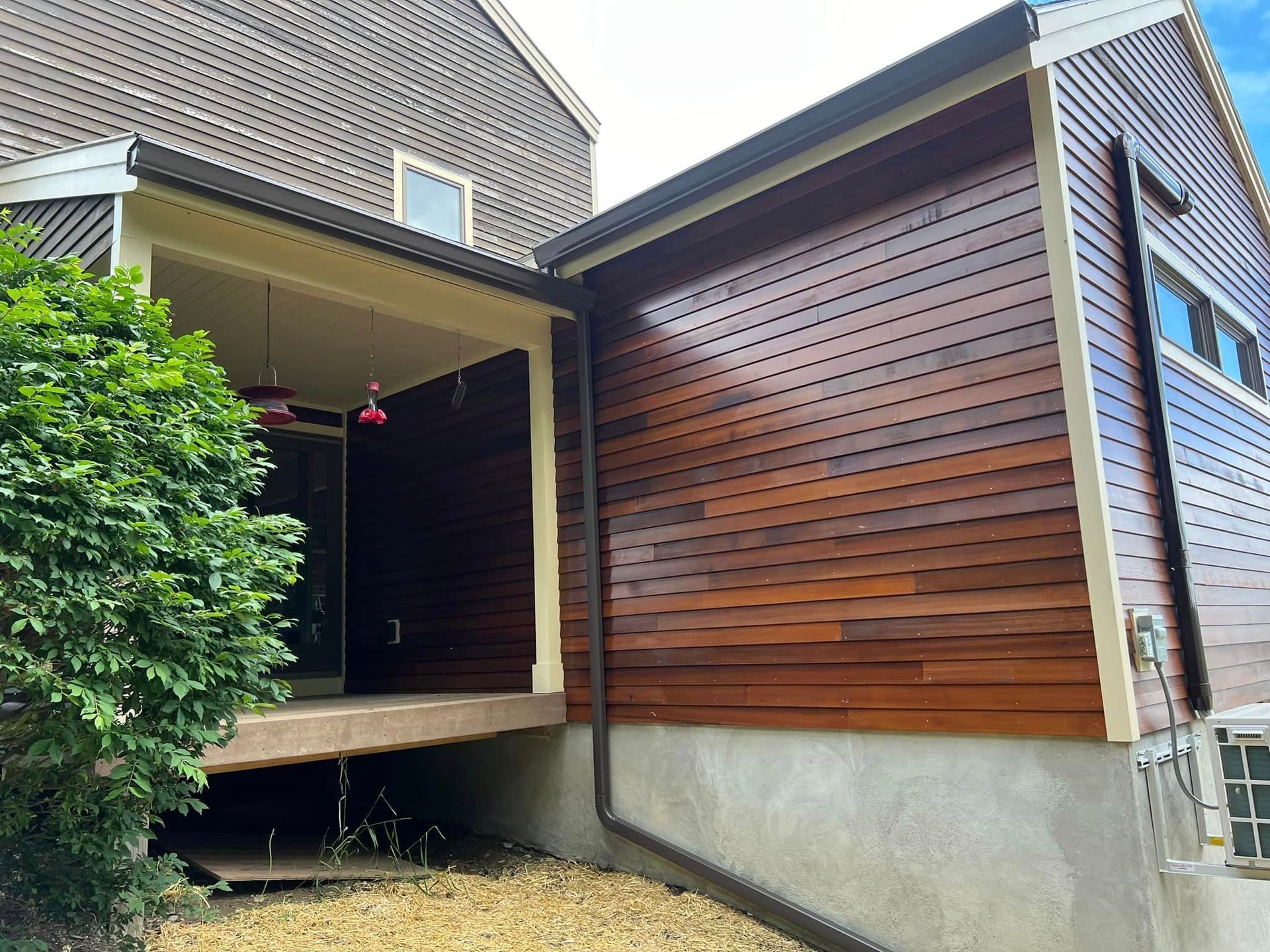 A house with a wooden siding on the side of it