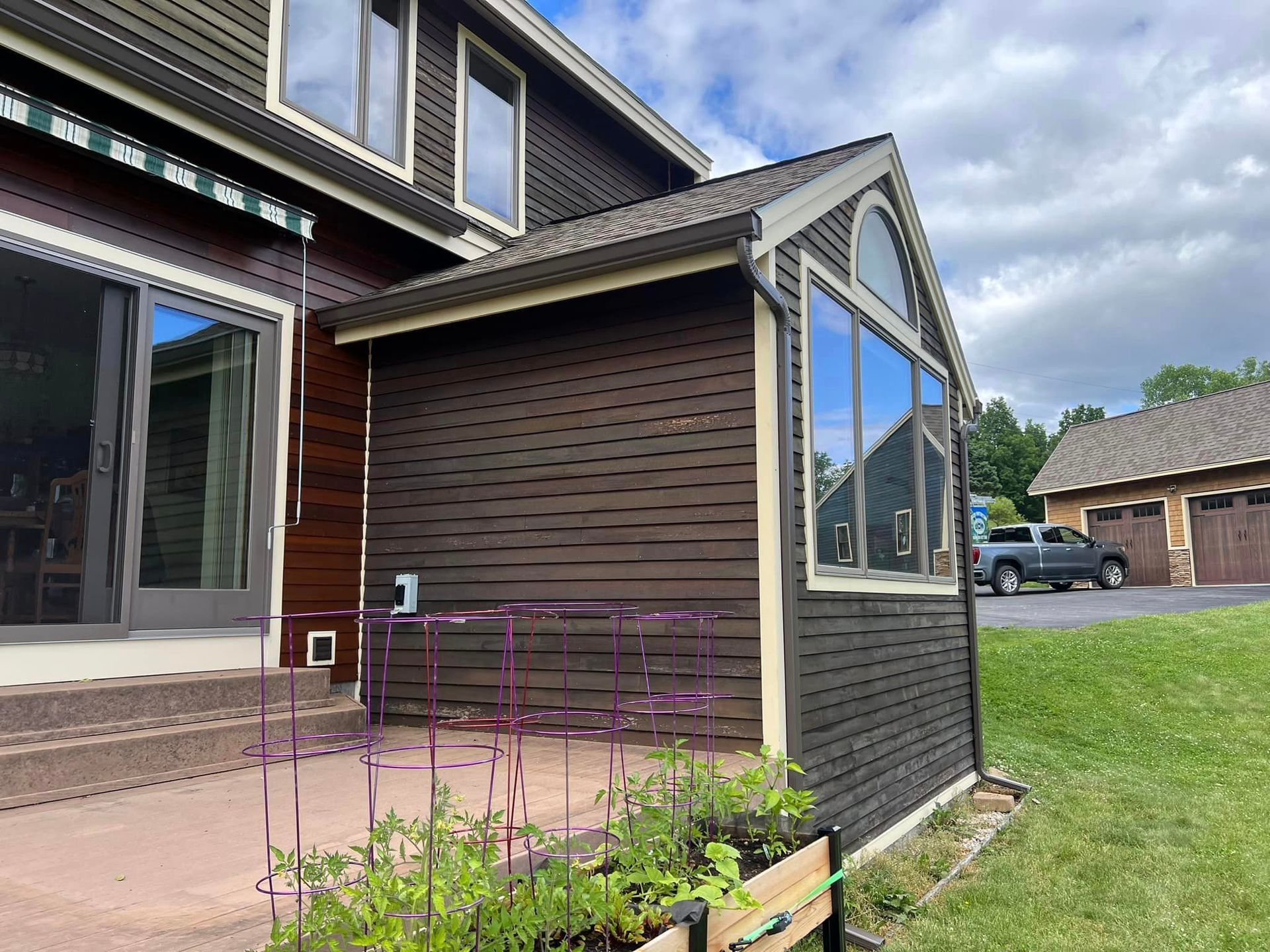 A large house with a shed on the side of it