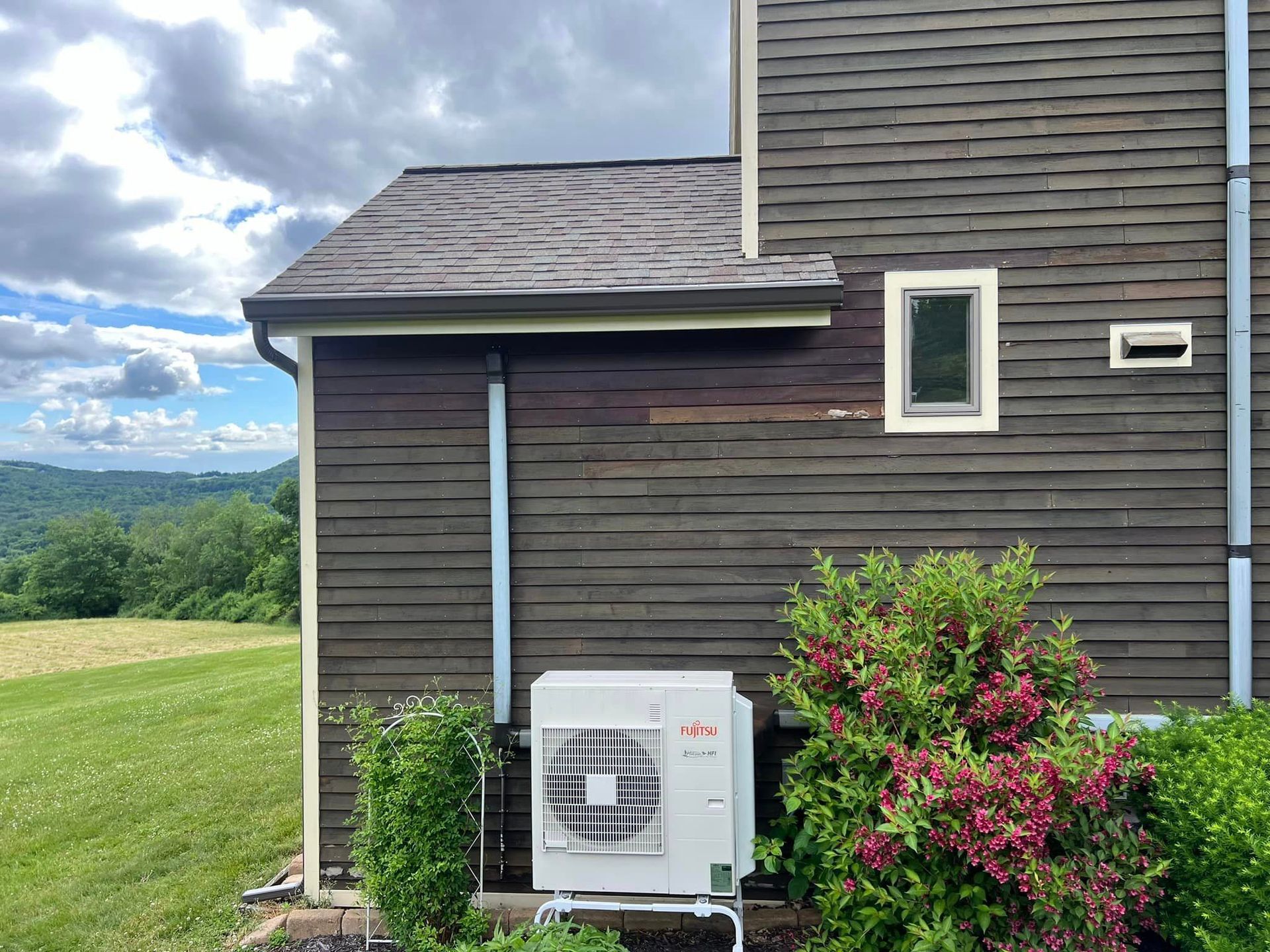 A house with a large air conditioner on the side of it