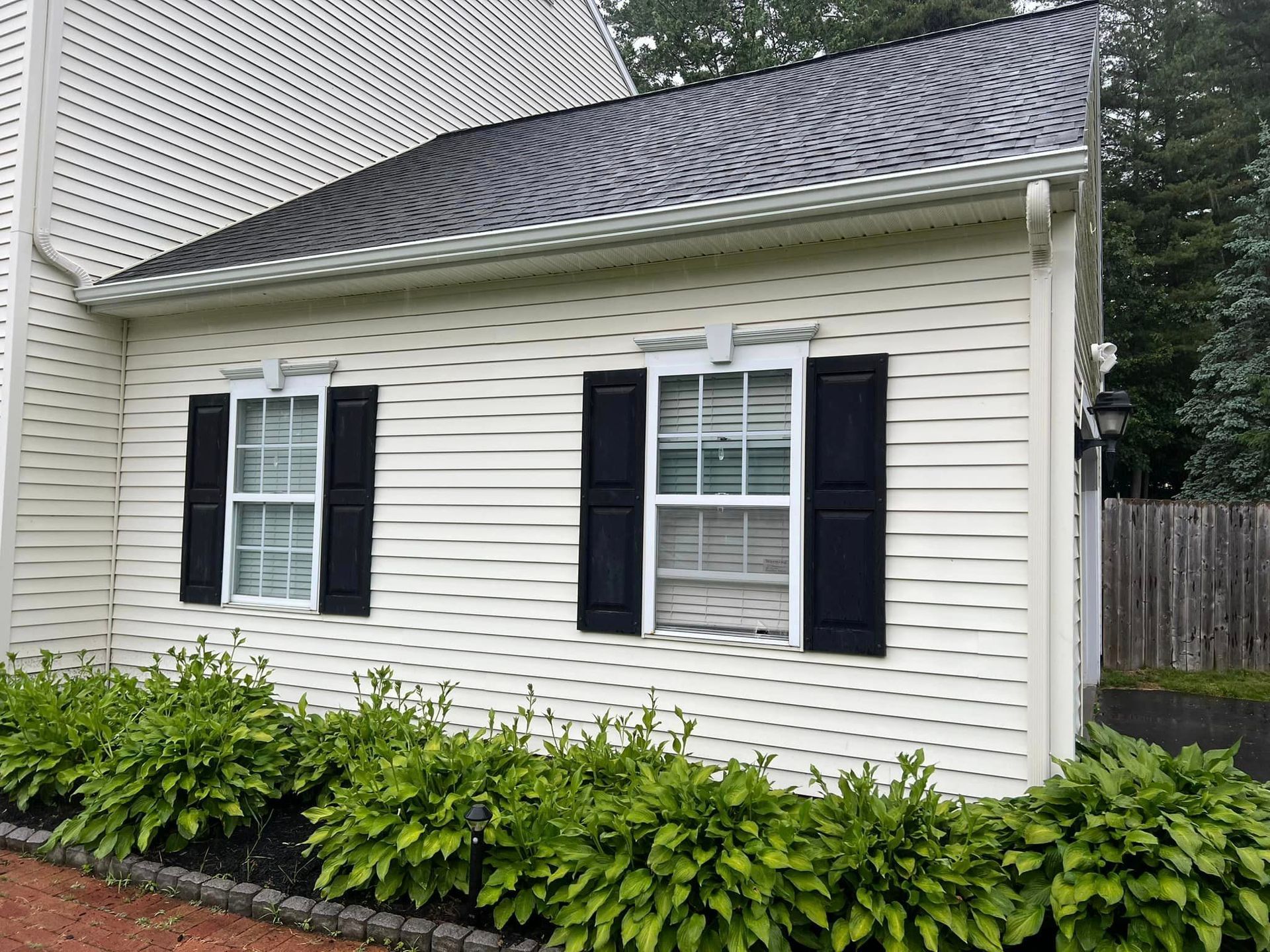 A white house with black shutters on the windows