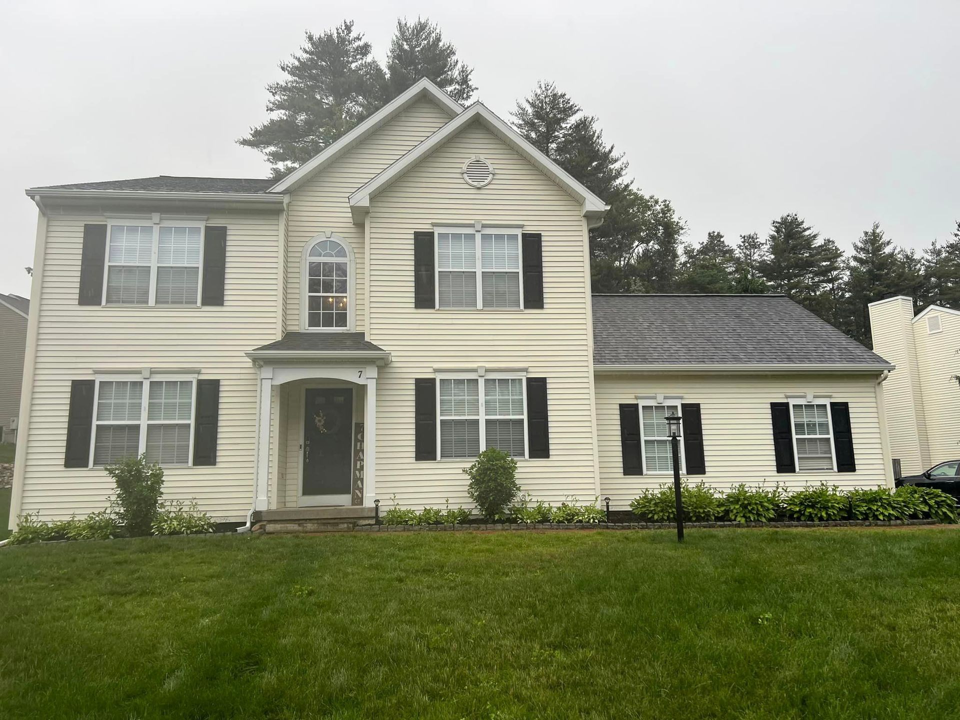 A large white house with black shutters on the windows