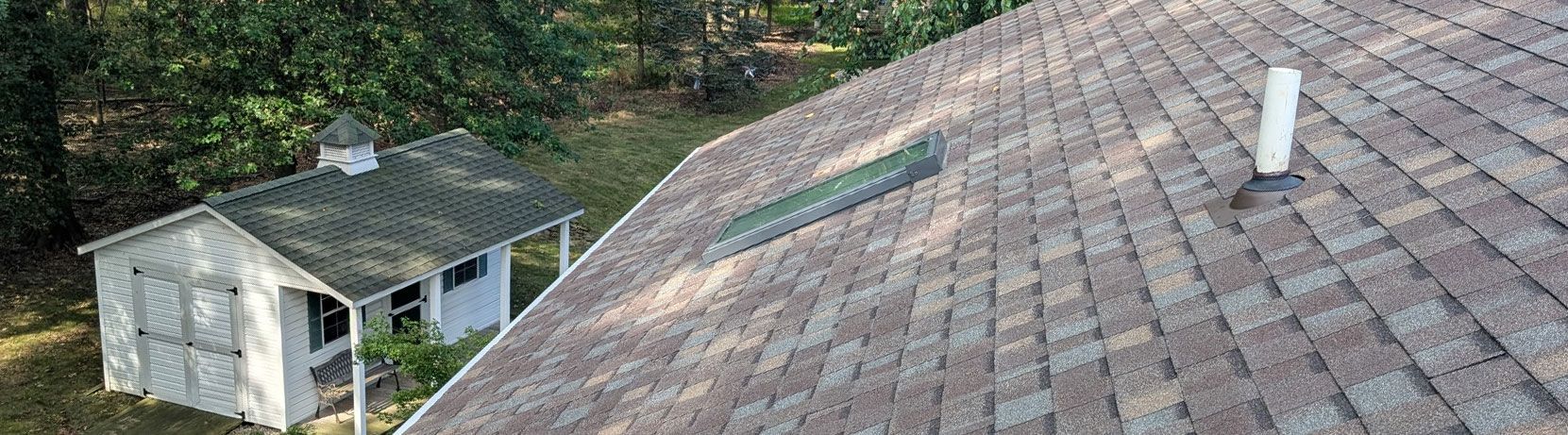 An aerial shot shows a roof with a pipe and a small shed.