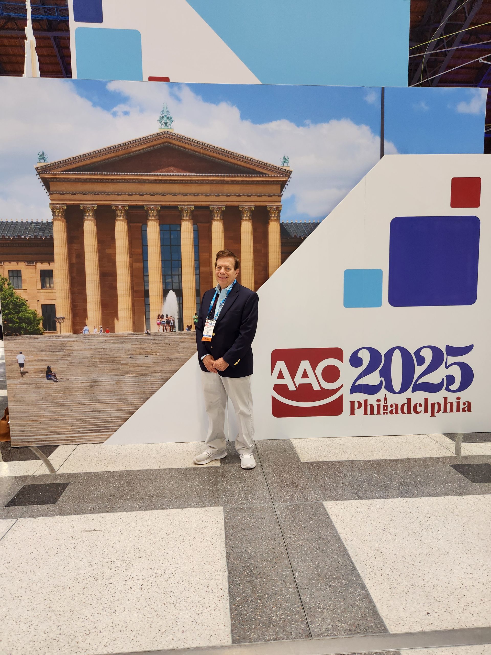 A man stands in front of a sign