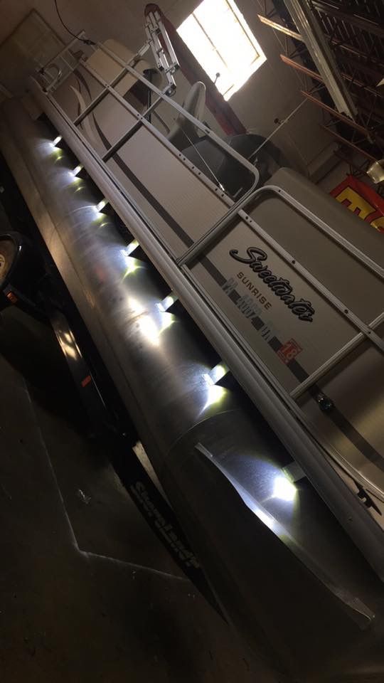Tilted view of a lit industrial walkway or conveyor with railings and bright window light