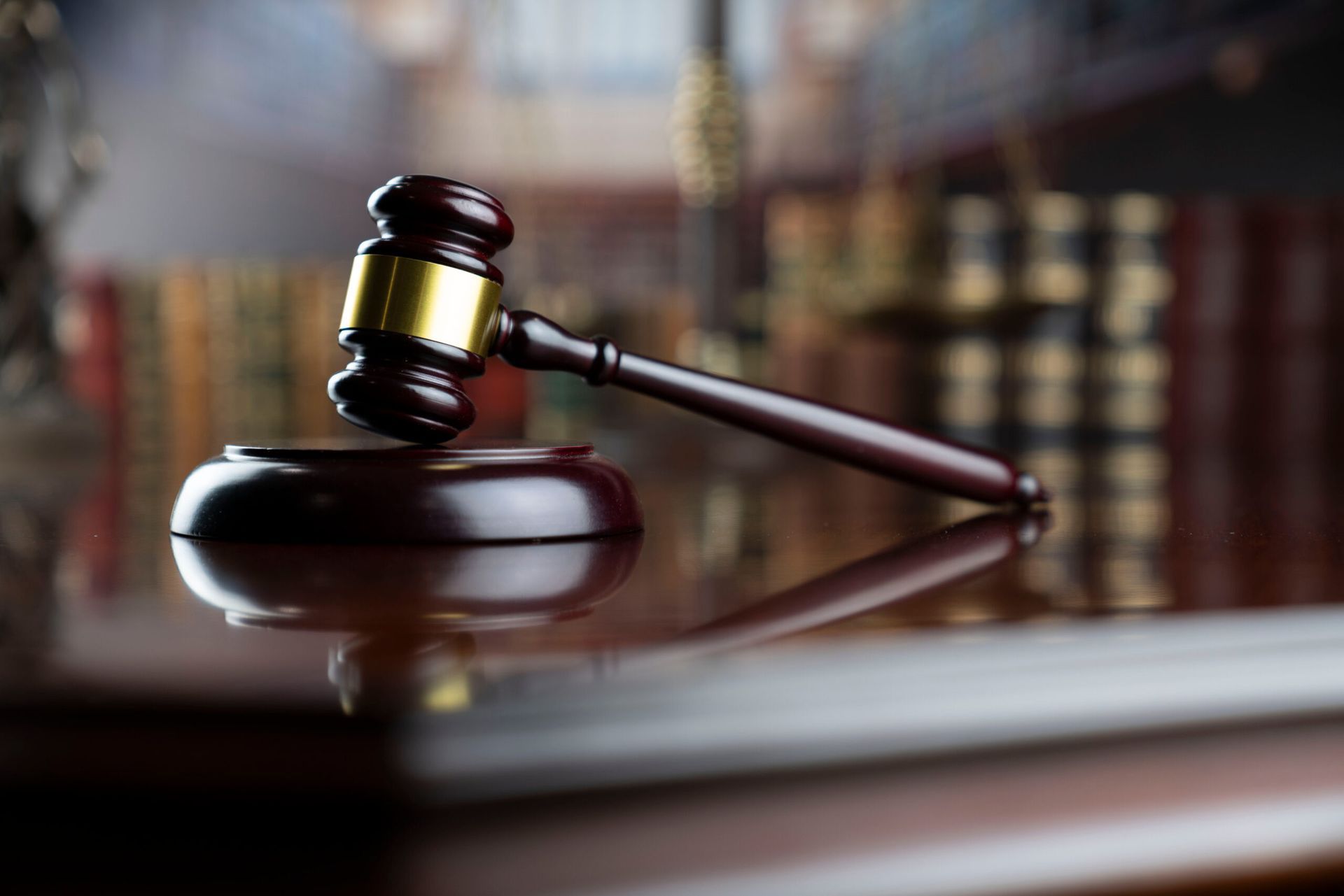 Judge’s gavel on a wooden desk in a courtroom setting
