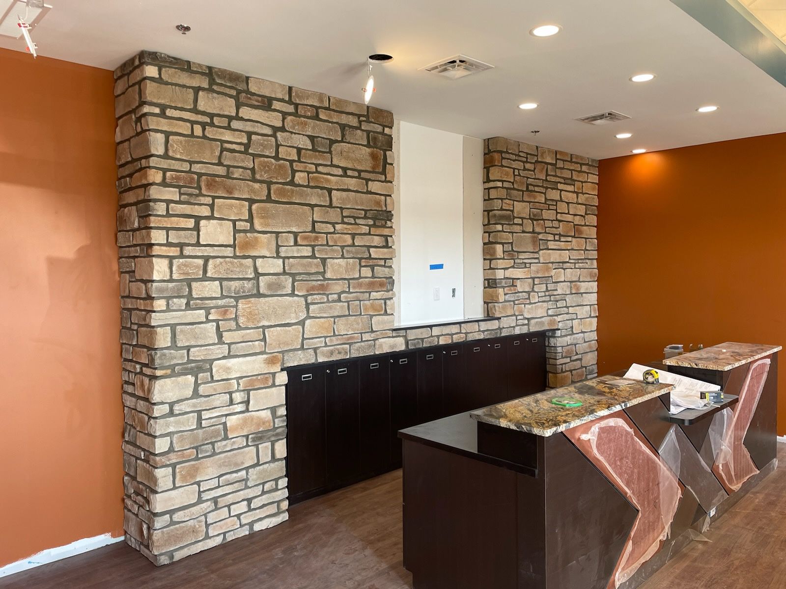 A room with a stone wall and a counter