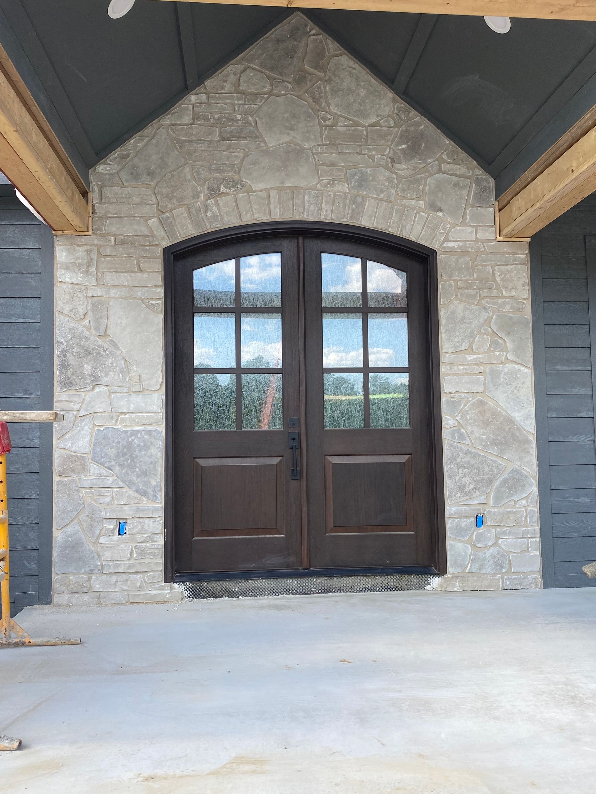 A brick building with a wooden door in front of it