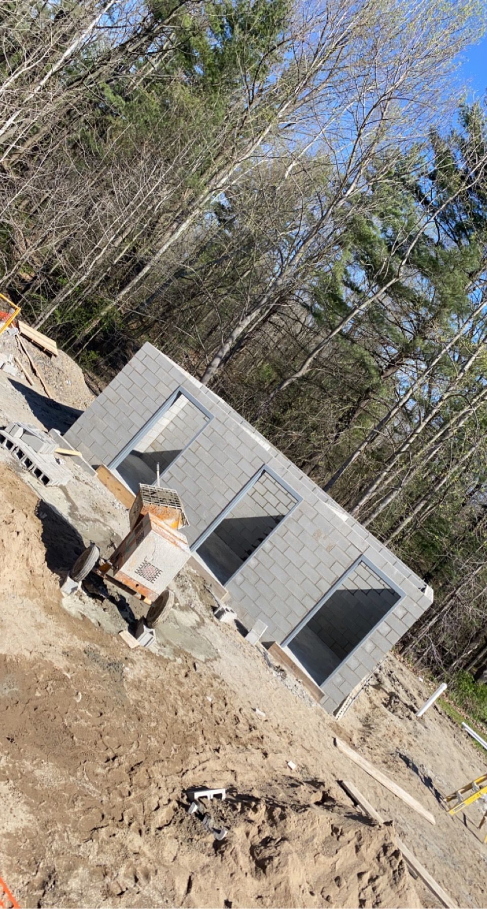 A building is being built in the middle of a forest.