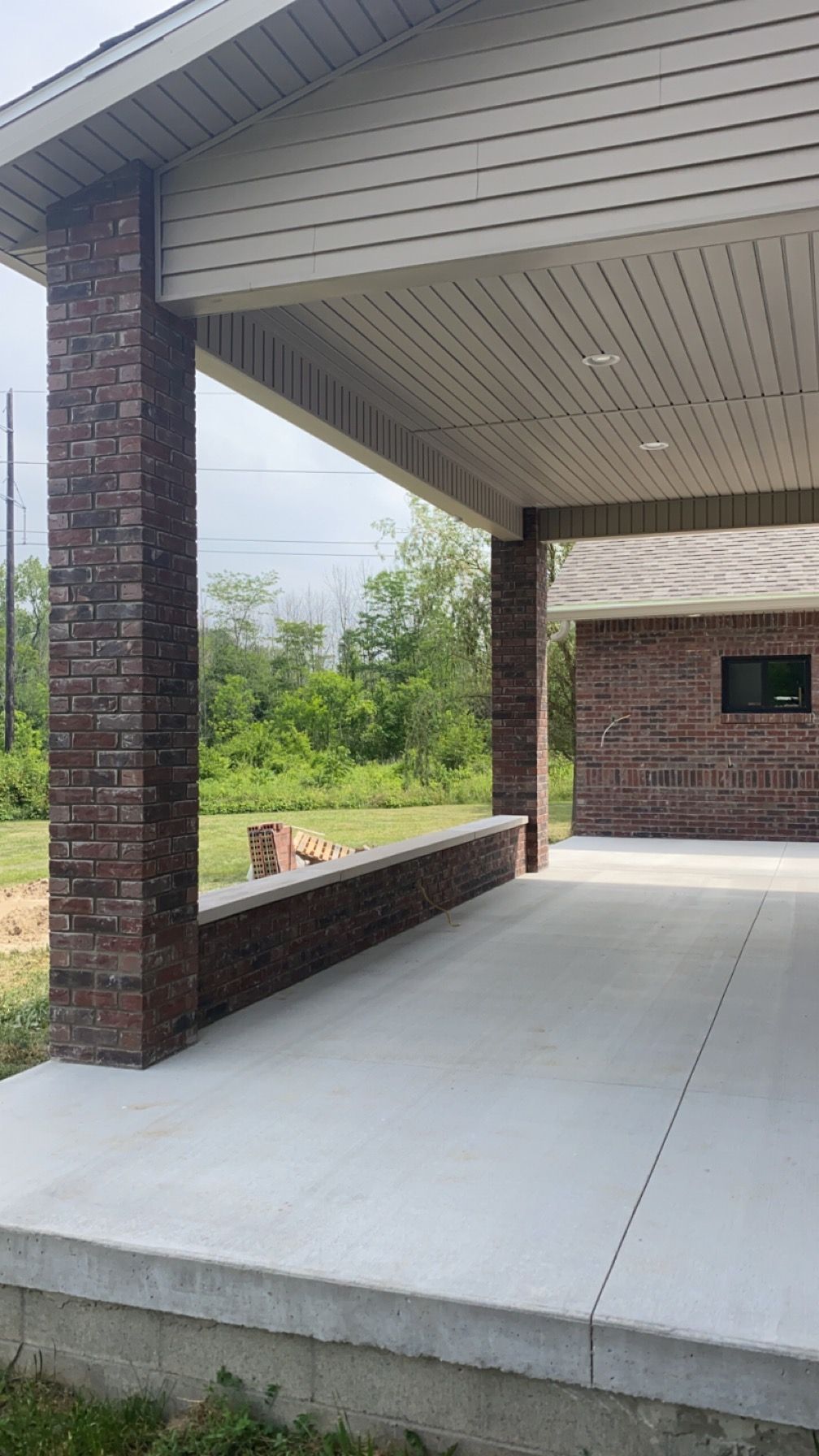 A brick building with a covered walkway leading to it.