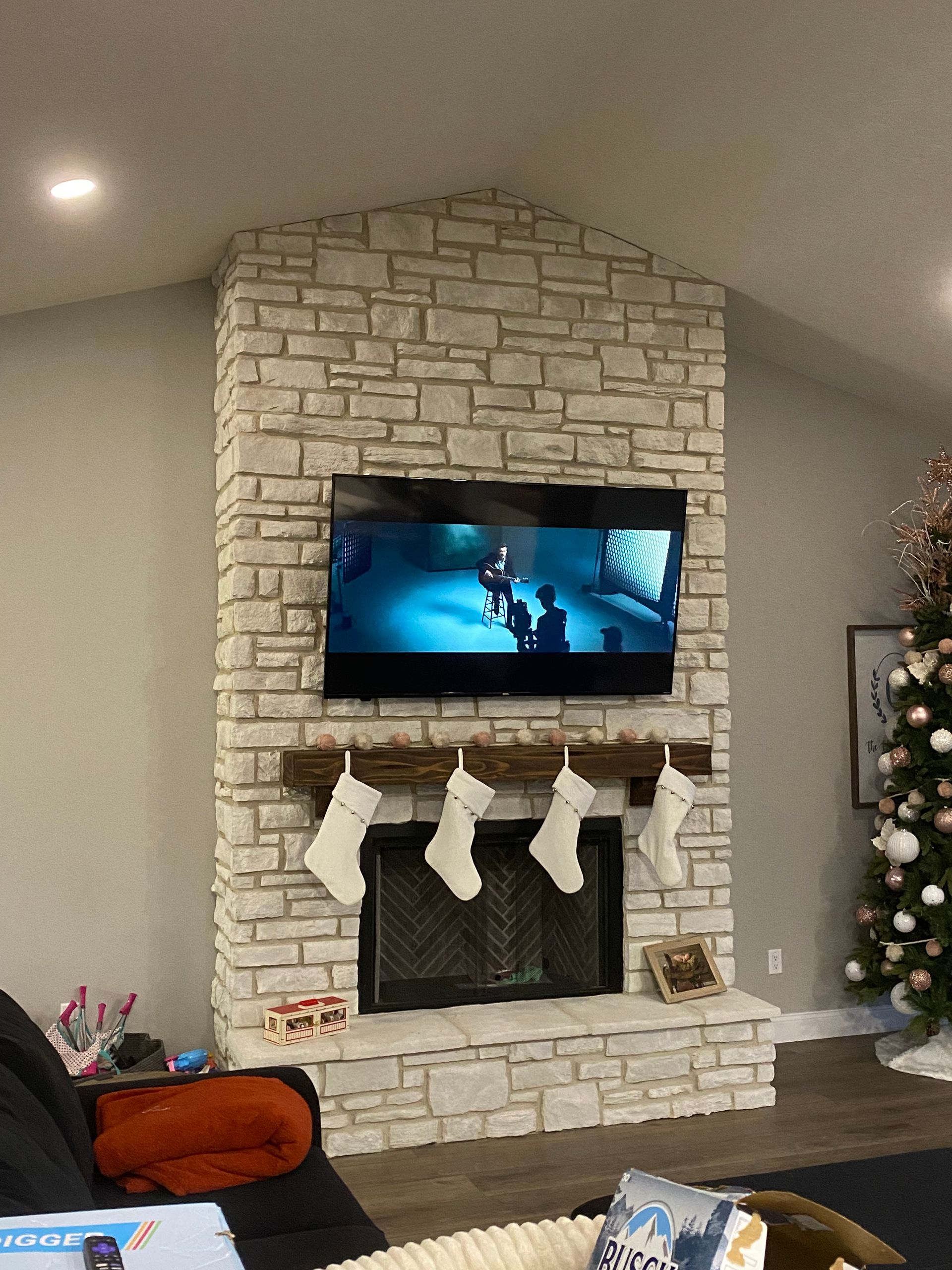 A living room with a fireplace and a flat screen tv.
