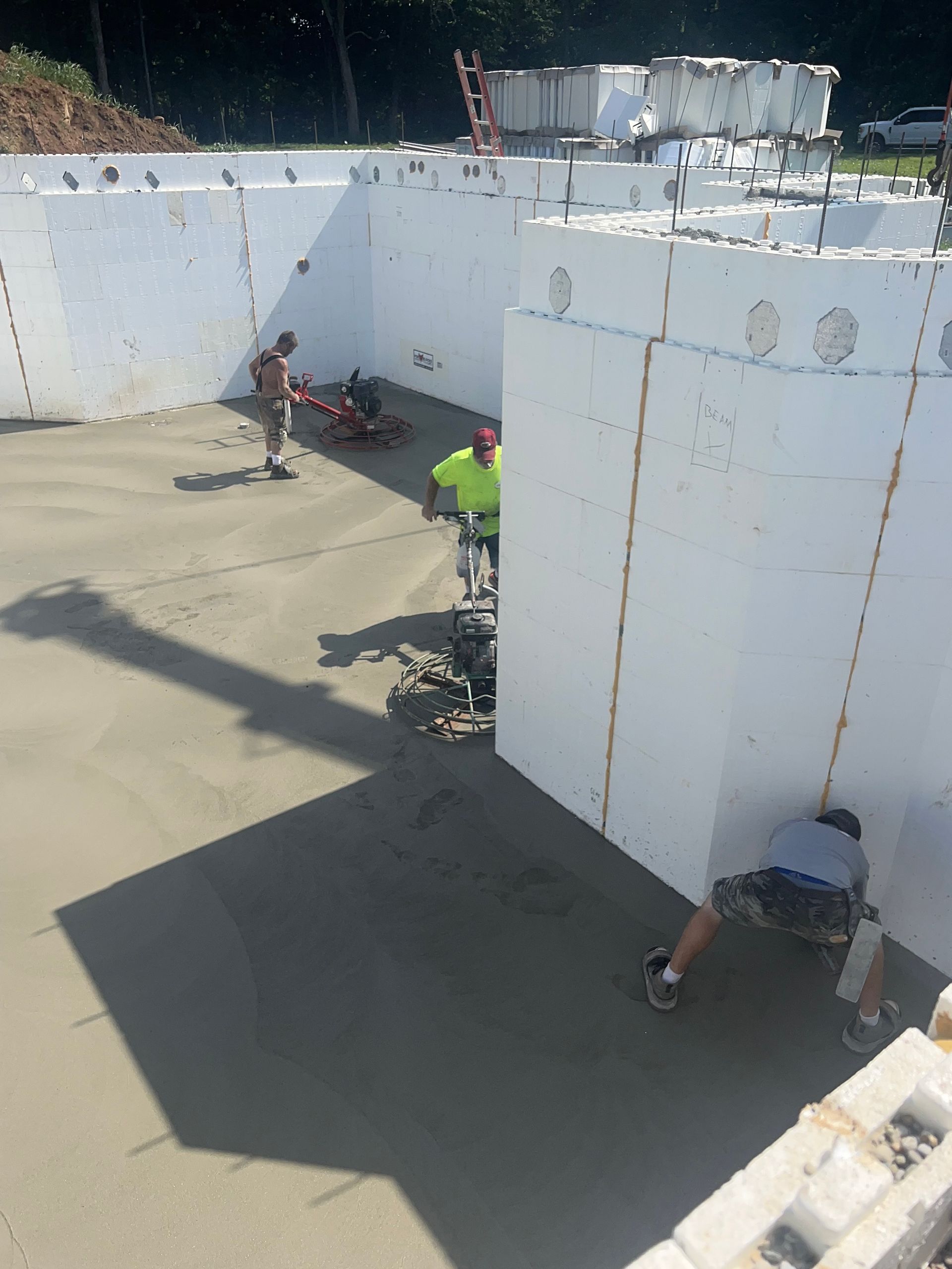 A group of people are working on a concrete floor