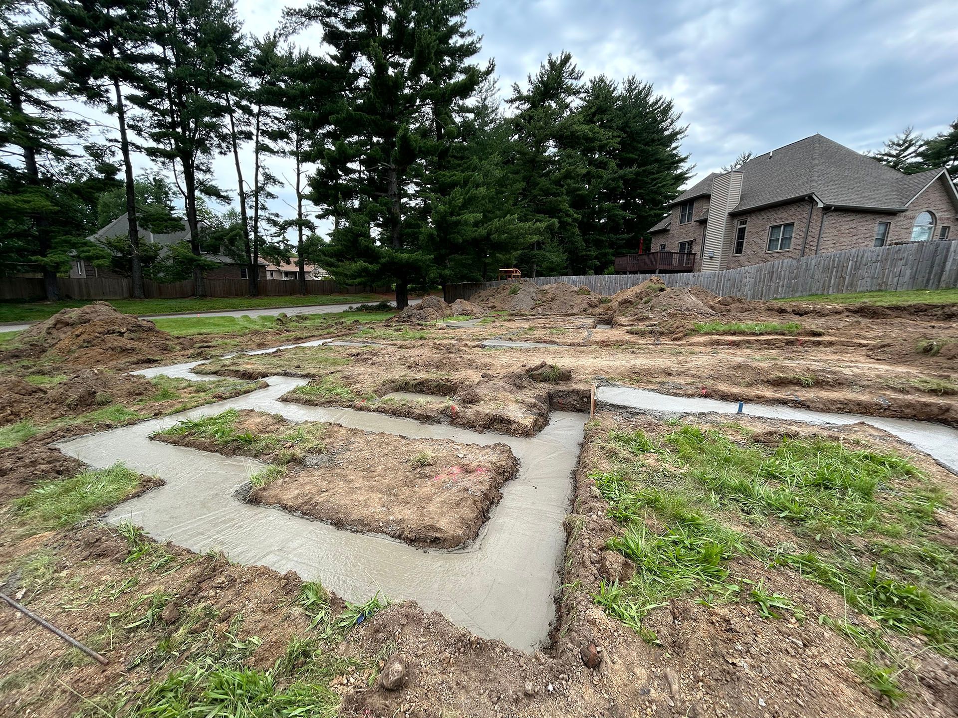 A house is being built in the middle of a dirt field.