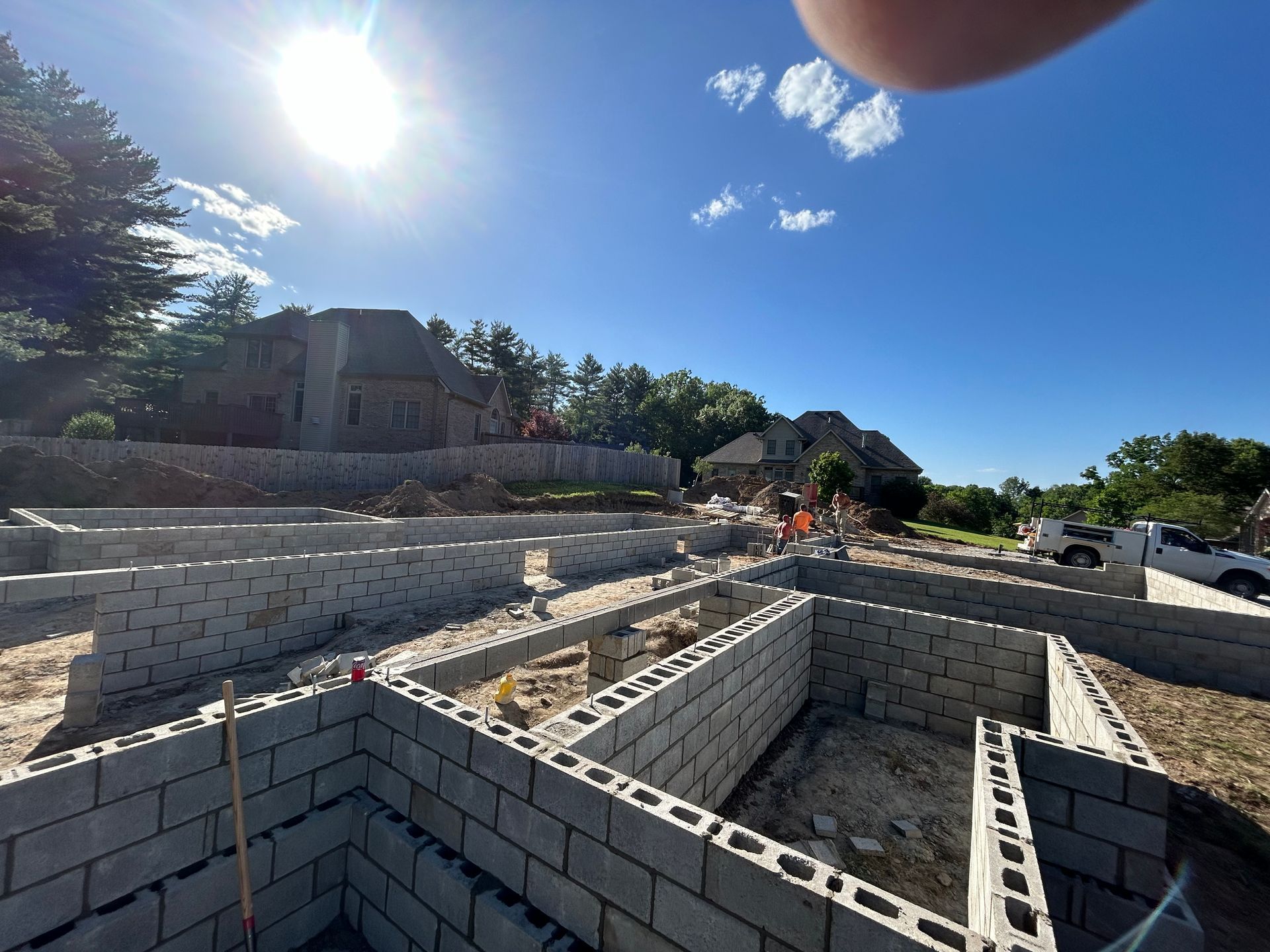A person is taking a picture of a house under construction.