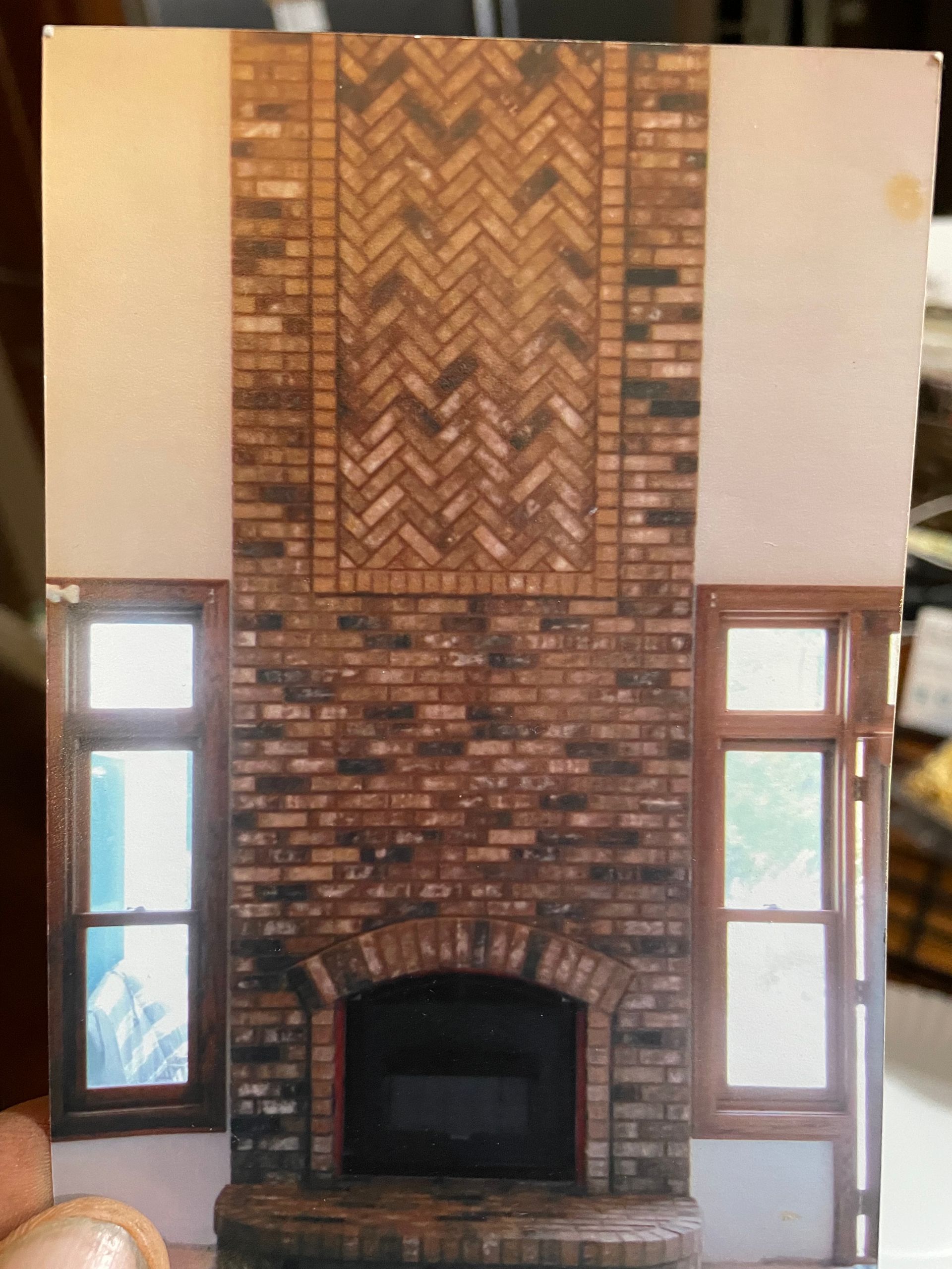 A picture of a brick fireplace with a herringbone pattern