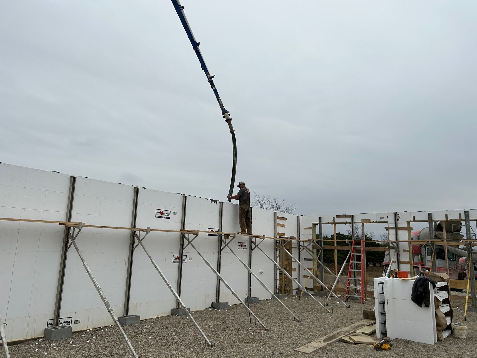 A man is working on a wall with a crane attached to it