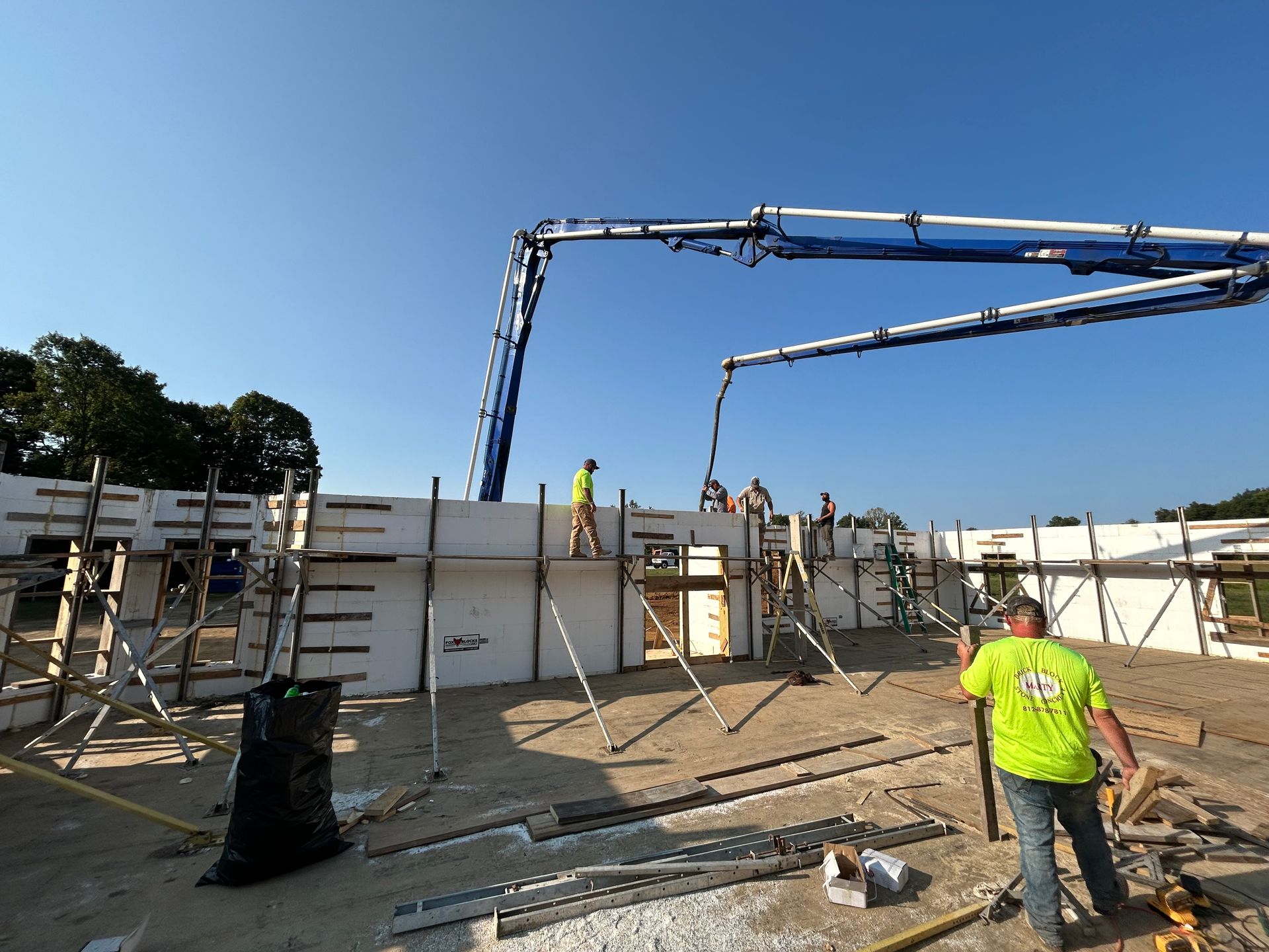 A man in a green shirt is working on a construction site
