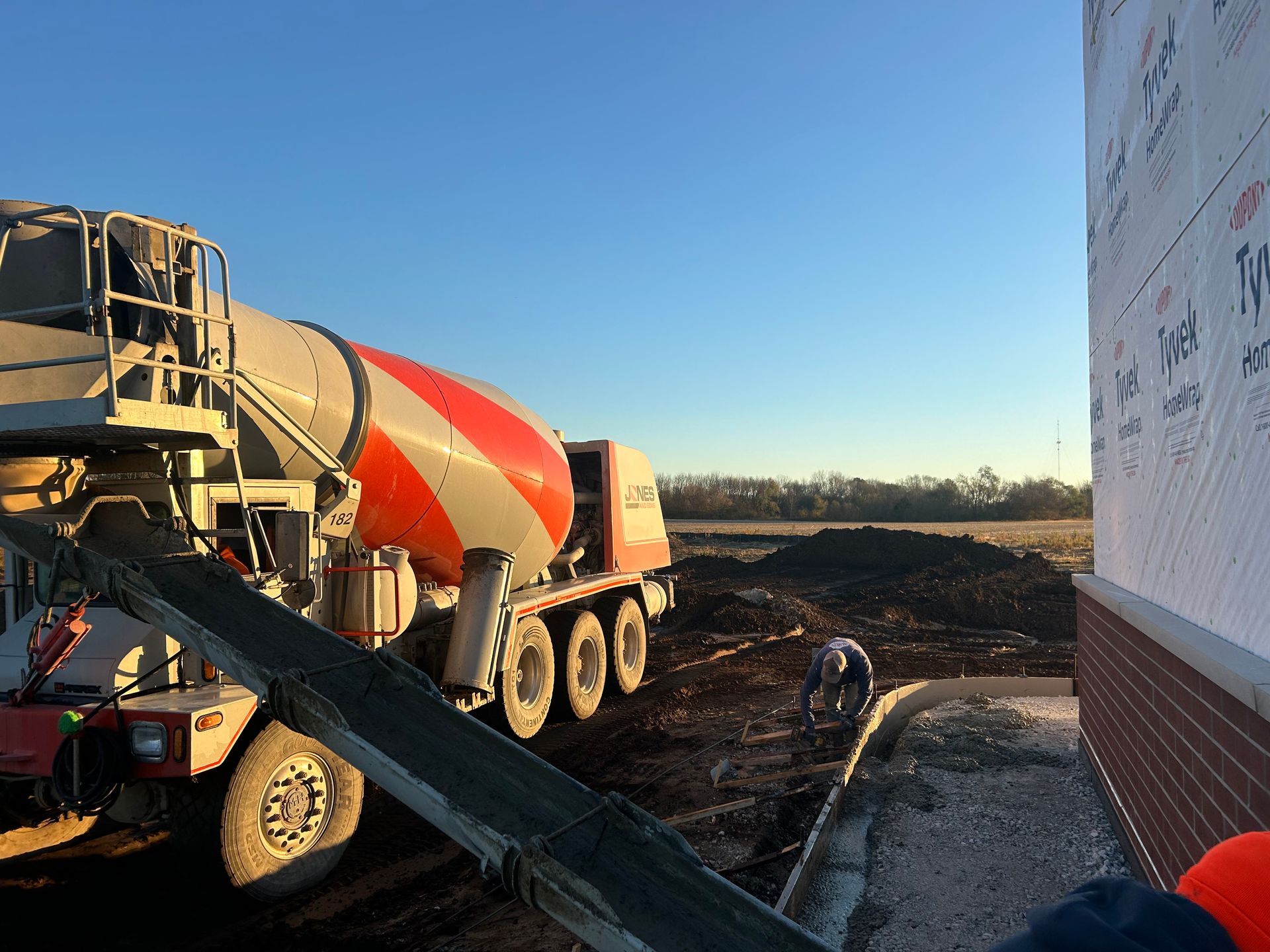 A concrete mixer is pouring concrete on a construction site