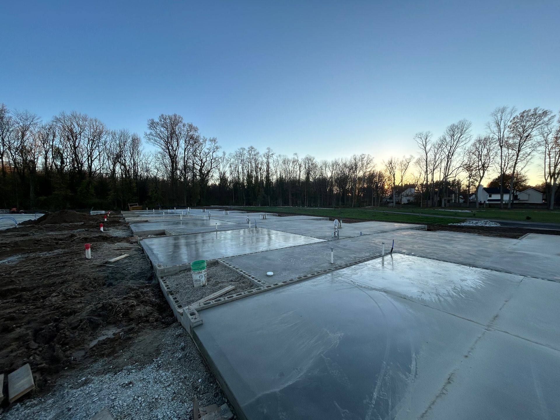 A construction site with a lot of water and trees in the background.