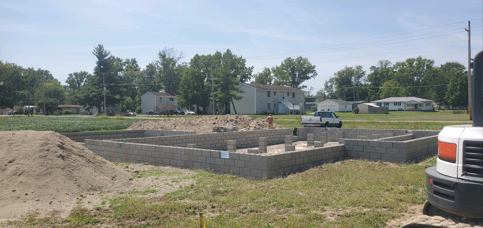 A construction site with a truck parked in the middle of it.