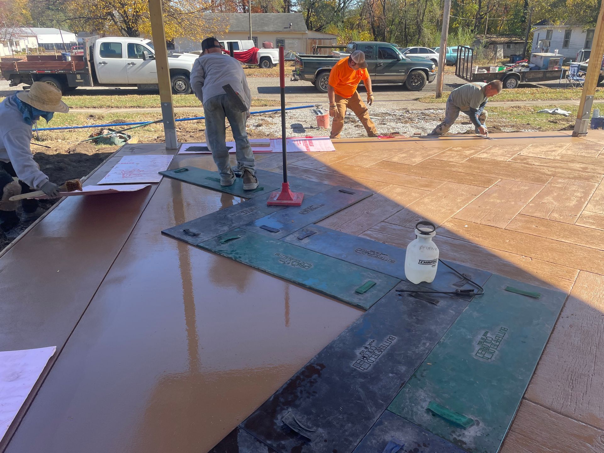 A group of construction workers are working on a concrete floor.