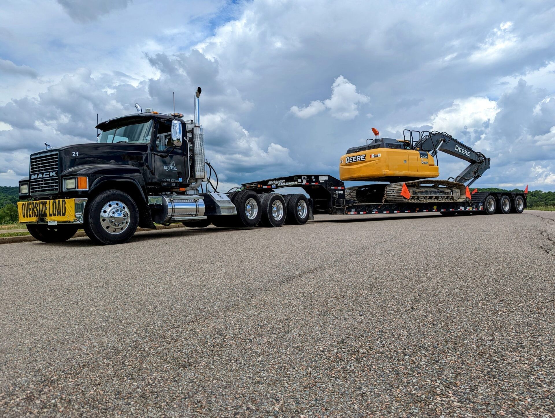 Big rig truck hauling an excavator