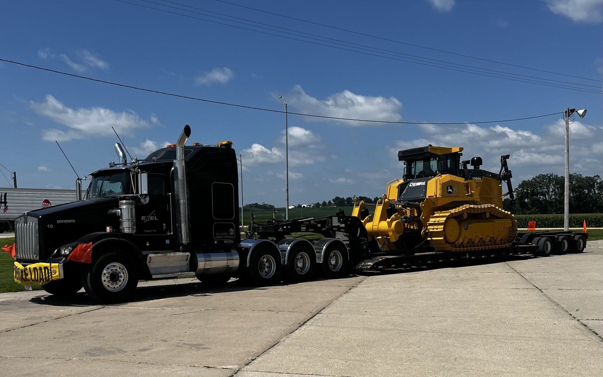 Big rig truck hauling a heavy machinery