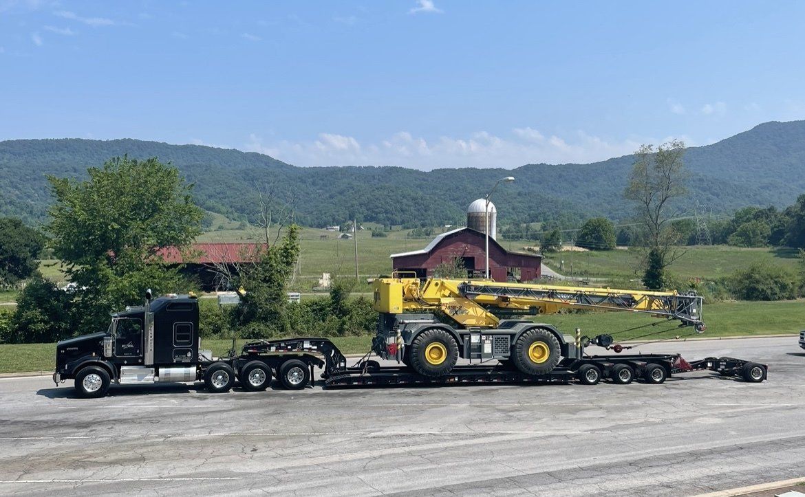 Big rig truck hauling a crane