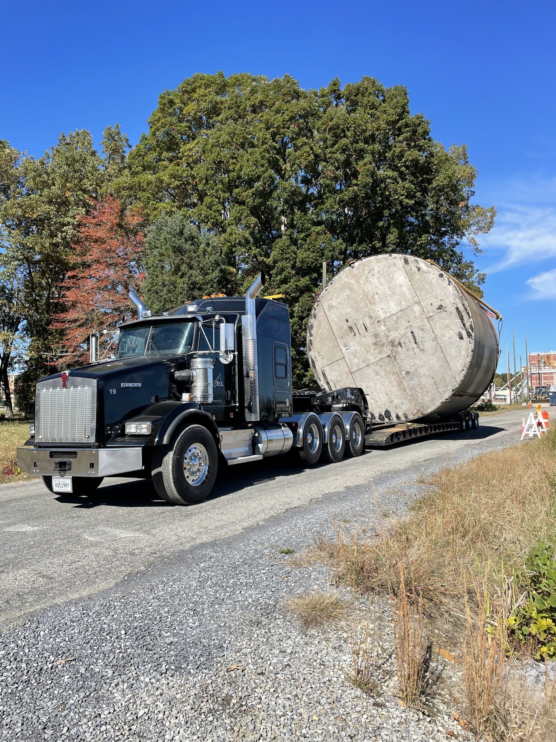 Big rig truck hauling a huge cylindrical concrete