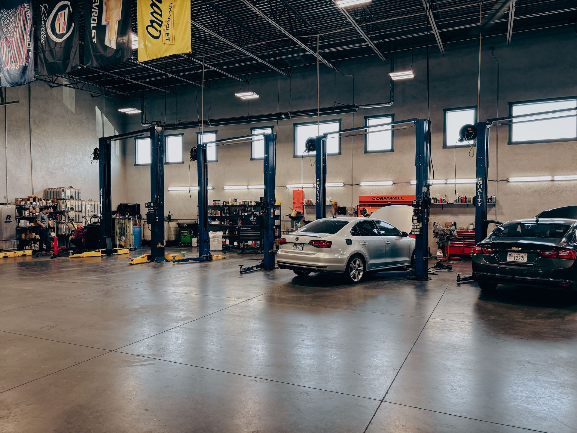 Auto repair shop interior with cars on lifts.
